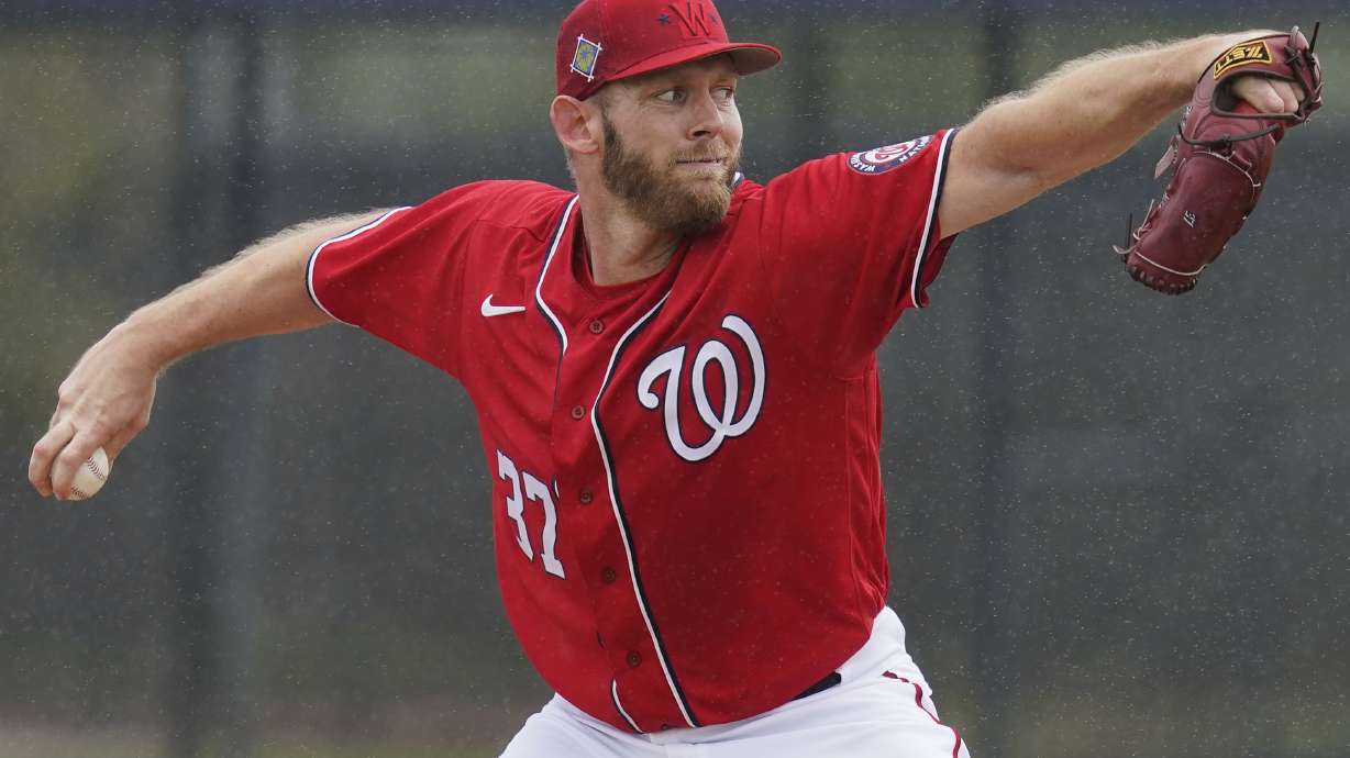 FILE - Washington Nationals pitcher Stephen Strasburg throws live batting practice in a drizzle during the team's spring training baseball workout March 15, 2022, in West Palm Beach, Fla. Strasburg is scheduled to make his season debut against the Miami Marlins on Thursday. The 33-year-old Strasburg has been sidelined for most of the past two seasons. He underwent surgery for thoracic outlet syndrome last summer and has not pitched since June 1, 2021.