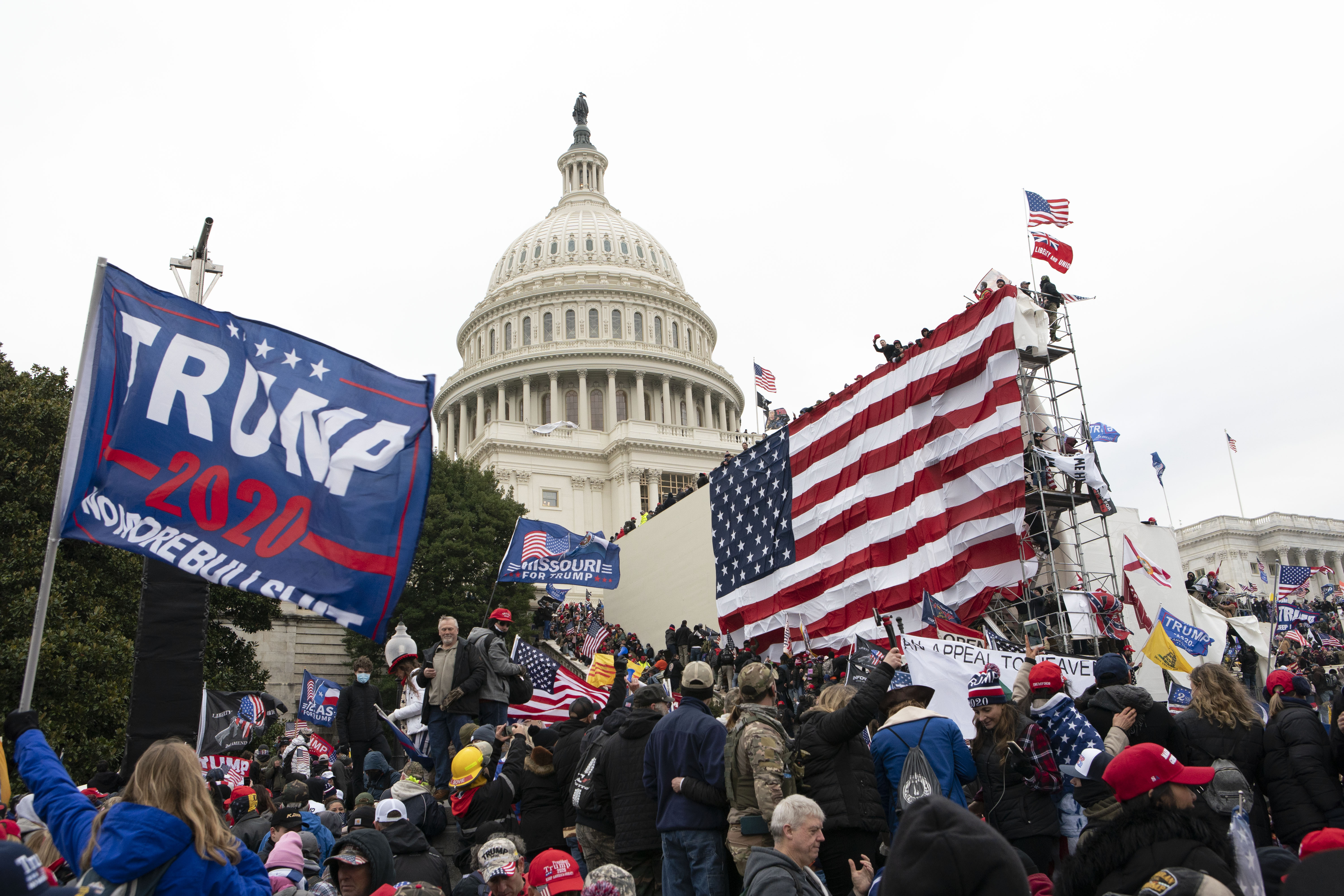 Insurrectionists stand outside the U.S. Capitol in Washington on Jan. 6, 2021. The House committee investigating the event is set to unveil as-yet-unreleased video, audio and a "mountain of evidence" in its prime-time hearing Thursday.