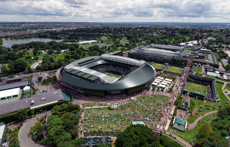 FILE PHOTO: Tennis - Wimbledon - All England Lawn Tennis and Croquet Club, London, Britain - July 5, 2021 General view as spectators watch a big screen outside court 1 during the fourth round