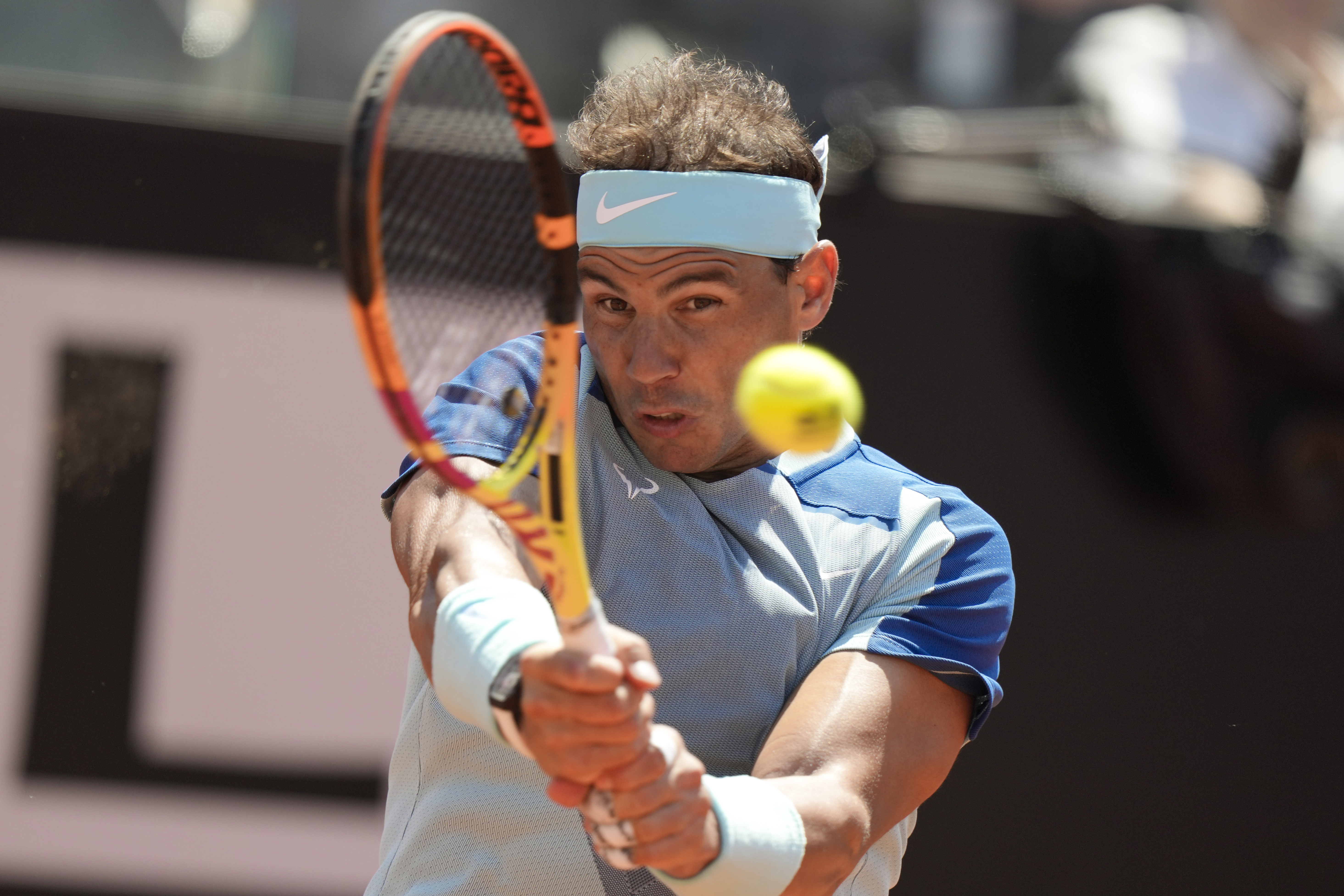 Rafael Nadal returns the ball to John Isner during their match at the Italian Open tennis tournament, in Rome, Wednesday, May 11, 2022. 