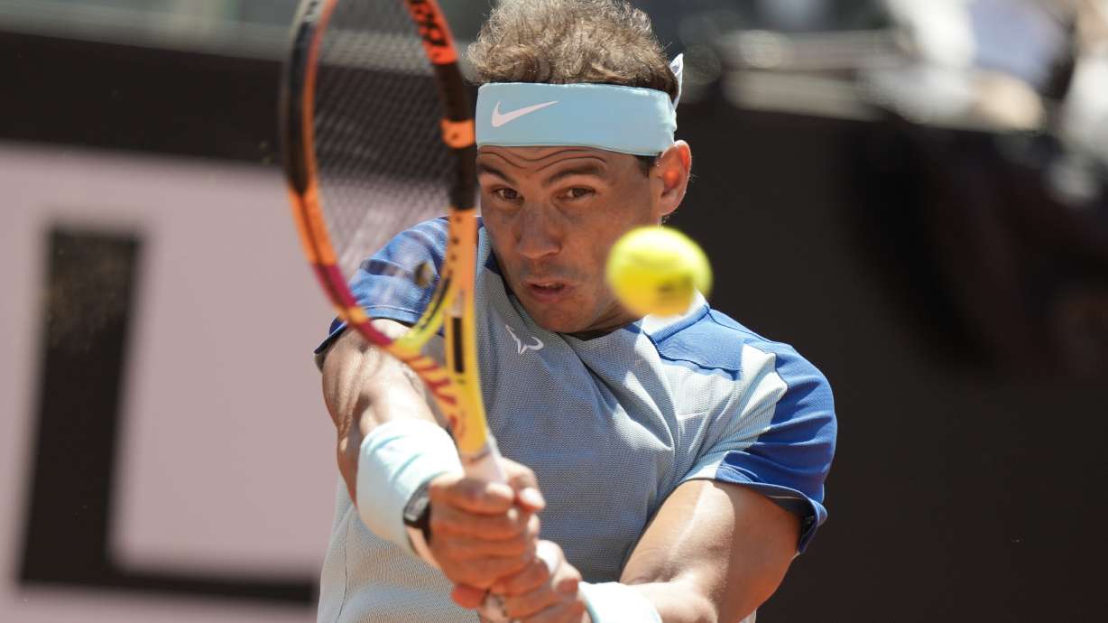 Rafael Nadal returns the ball to John Isner during their match at the Italian Open tennis tournament, in Rome, Wednesday, May 11, 2022.