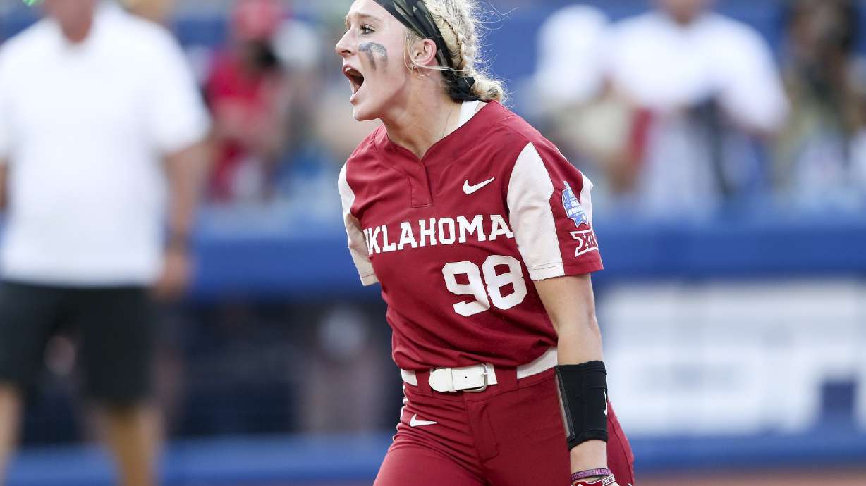 Oklahoma pitcher Jordyn Bahl (98) yells after striking out a Texas batter to end an inning during the second game of the NCAA softball Women's College World Series finals in Oklahoma City, Okla., Thursday, June 9, 2022.