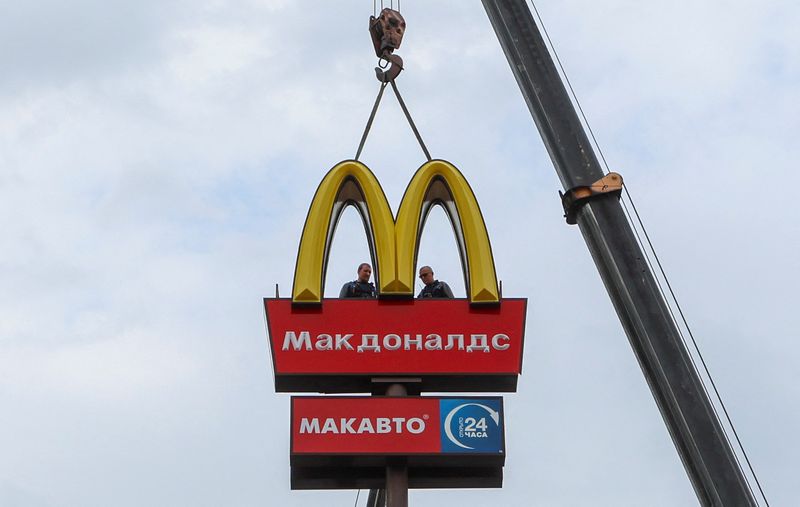 Workers use a crane to dismantle the McDonald's Golden Arches while removing the logo signage from a drive-through restaurant of McDonald's in the town of Kingisepp in the Leningrad region, Russia, Thursday.