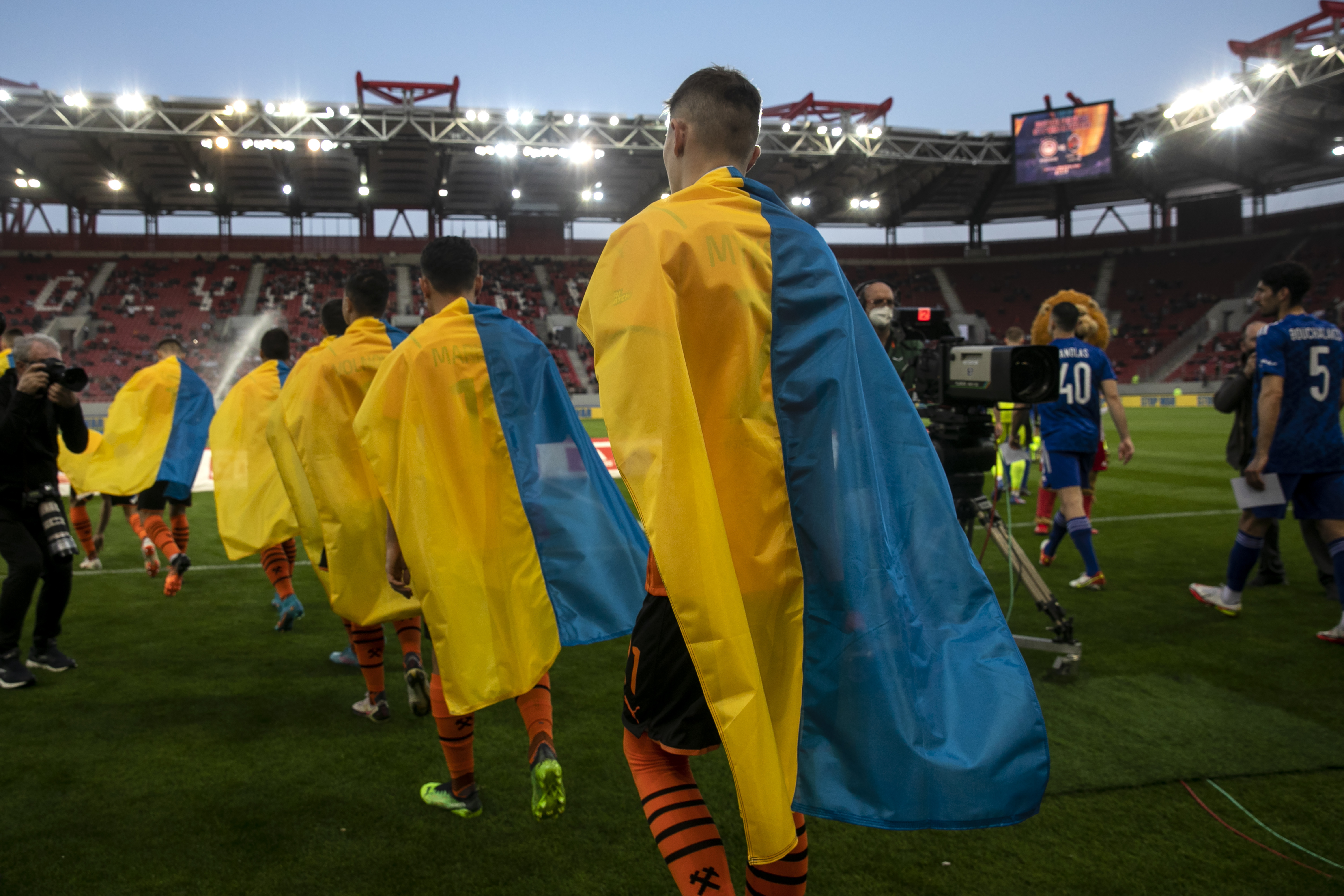 FILE - Players of Shakhtar Donetsk enter the pitch ahead of a friendly charity soccer match against Olympiakos at Karaiskaki stadium in Piraeus, near Athens, on Saturday, April 9, 2022. Ukraine’s top soccer team plans to host its Champions League games in Poland and make a humanitarian tour of the United States. They feel like natural next steps for Shakhtar Donetsk after eight years exiled from its home city by Russian aggression. Shakhtar has played only away games since conflict in its Donbas region started in 2014. 