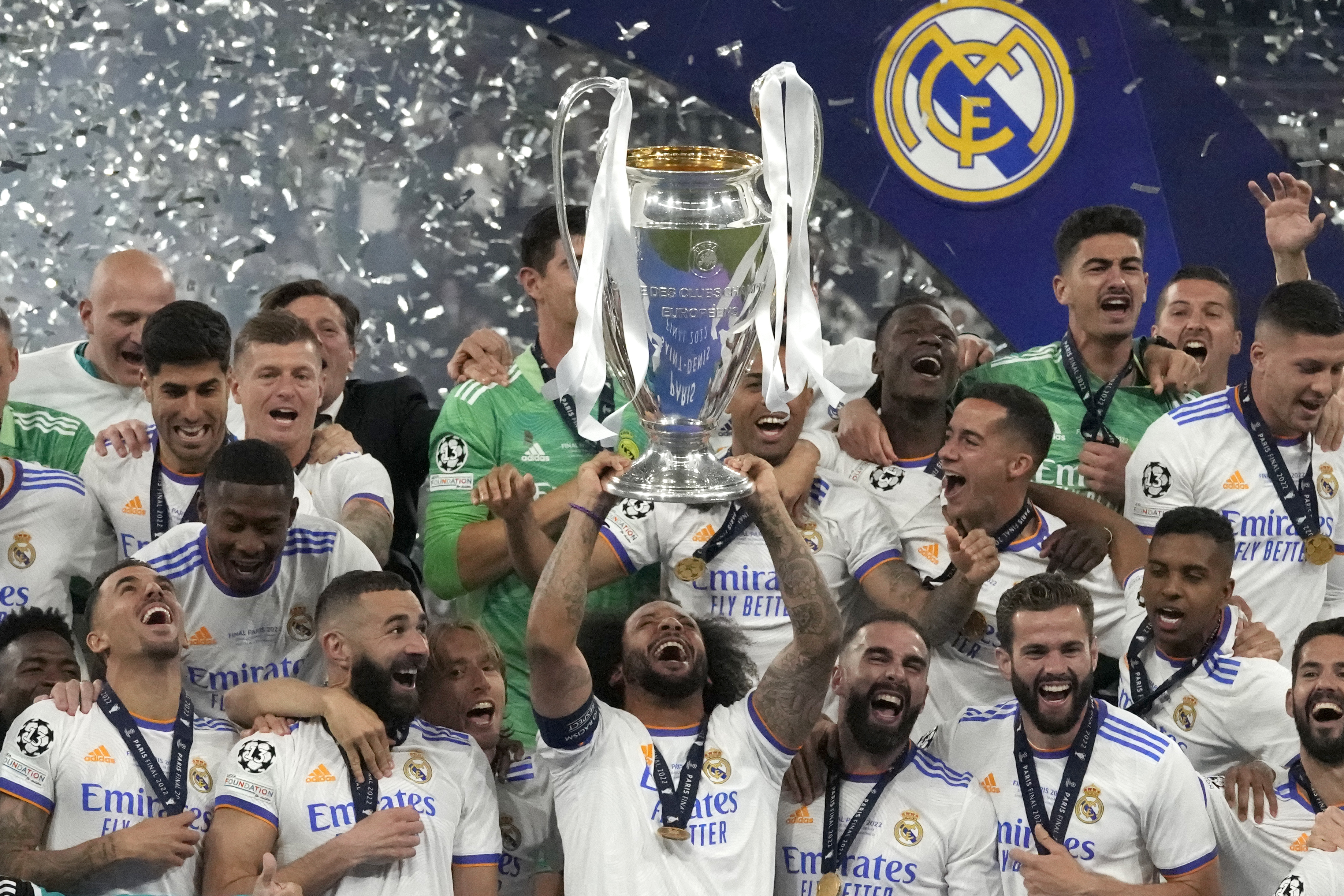 Real Madrid's Marcelo lifts the trophy as players celebrate winning the Champions League final soccer match between Liverpool and Real Madrid at the Stade de France in Saint Denis near Paris, Saturday, May 28, 2022.