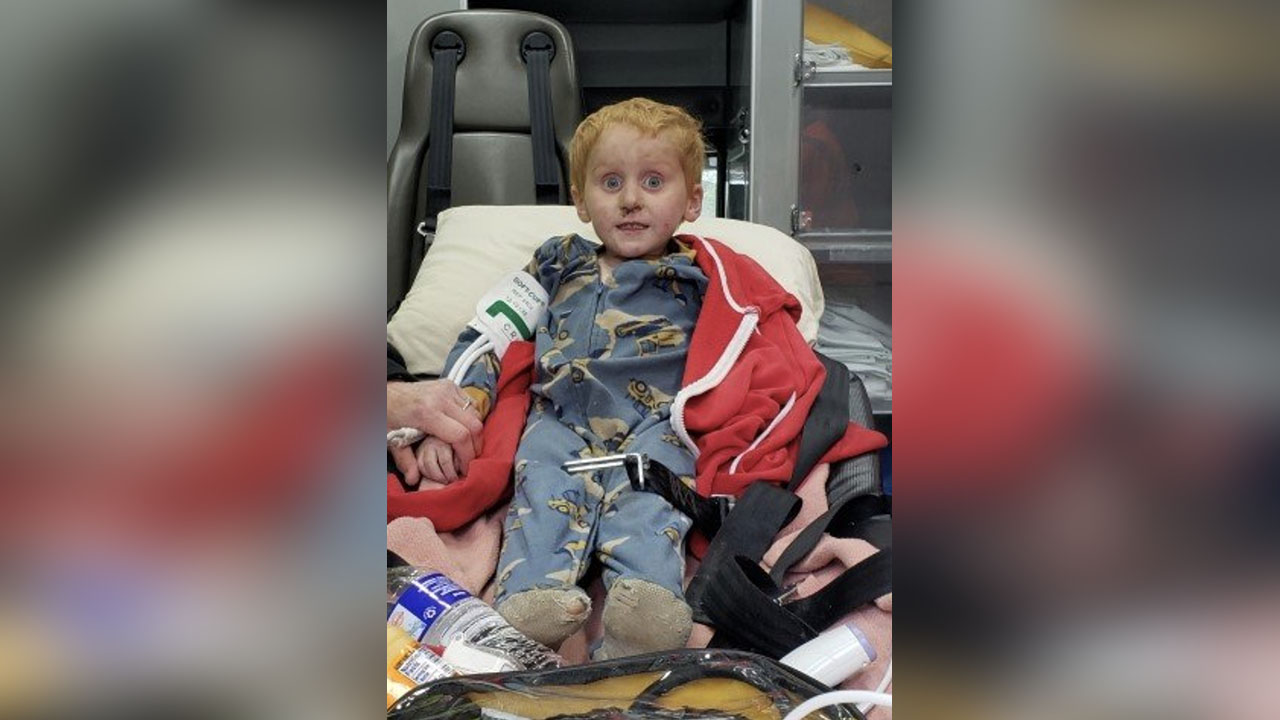 Ryker Webb, 3, is pictured in the back of an ambulance after being lost in the Montana wilderness for two days.
