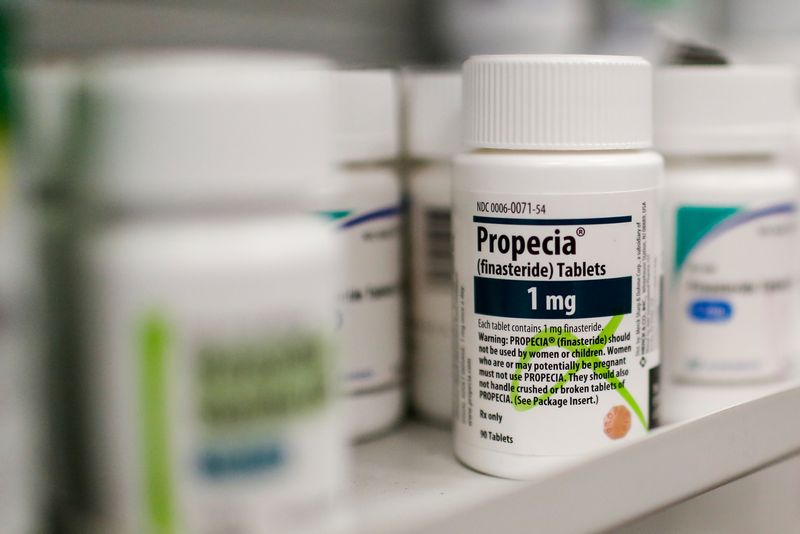 U.S. health regulators rejected a request to remove popular anti-baldness pill Propecia and its generic versions from the market, but for the first time required patient notification about reports of suicidal behavior in men taking the drug.