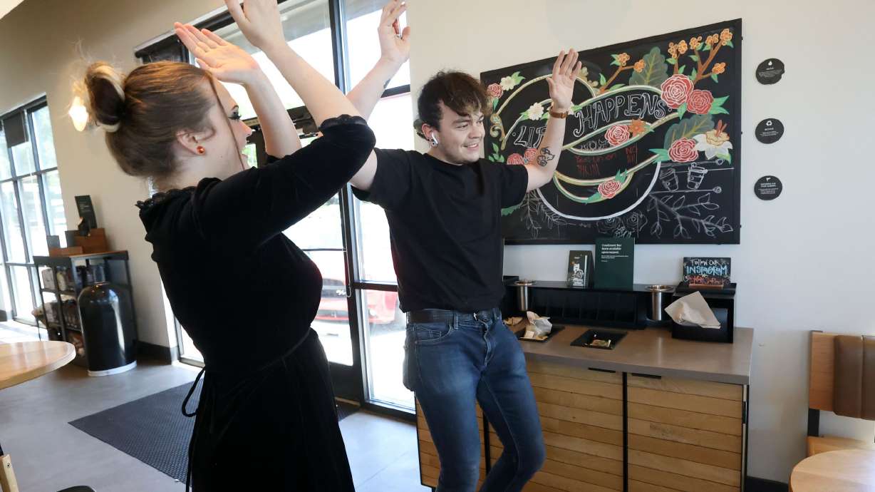 Starbucks shift leaders Brittany Glazier and Jacob Lawson celebrate as the majority of votes tallied by the National Labor Relations Board are in favor of unionizing at a Starbucks in Cottonwood Heights on Friday. The final tally was 11 votes in favor of unionizing and six votes against it.