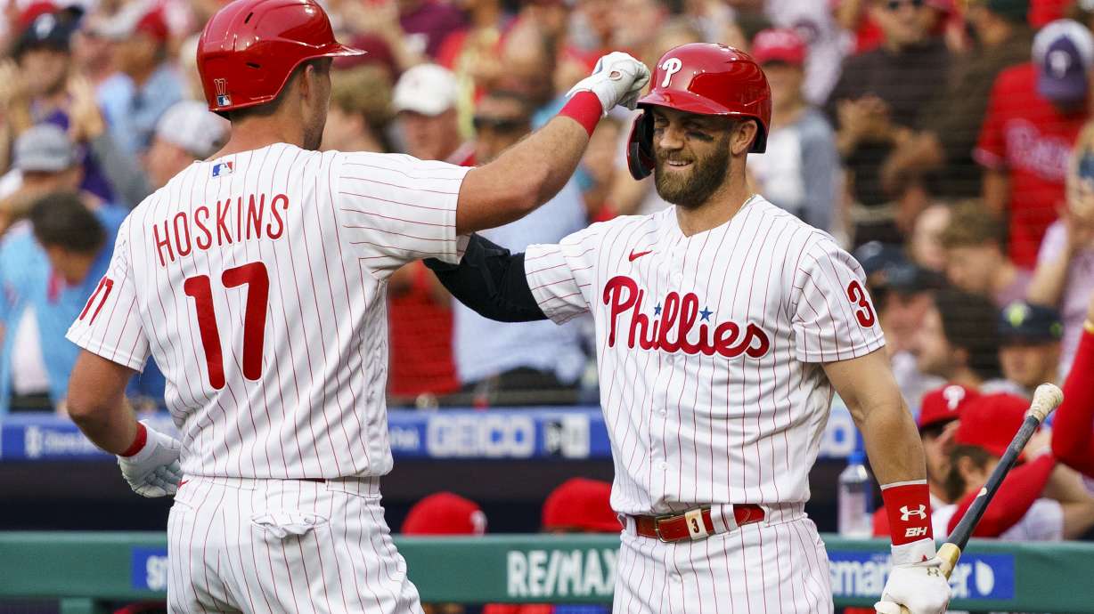 Philadelphia Phillies' Rhys Hoskins, left, celebrates his home run with Bryce Harper, right, during the first inning of a baseball game against the Arizona Diamondbacks, Friday, June 10, 2022, in Philadelphia.