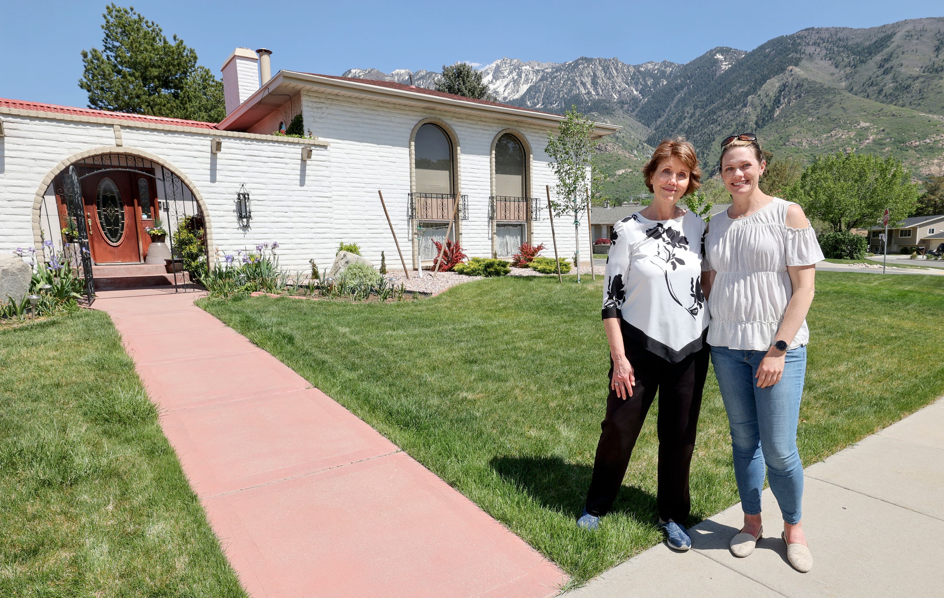 Maureen Gale and her daughter, Lara Gale, pose for a photo outside of their family’s home in Sandy on May 18. Lara, who grew up in the home, recently bought a house in Ogden.