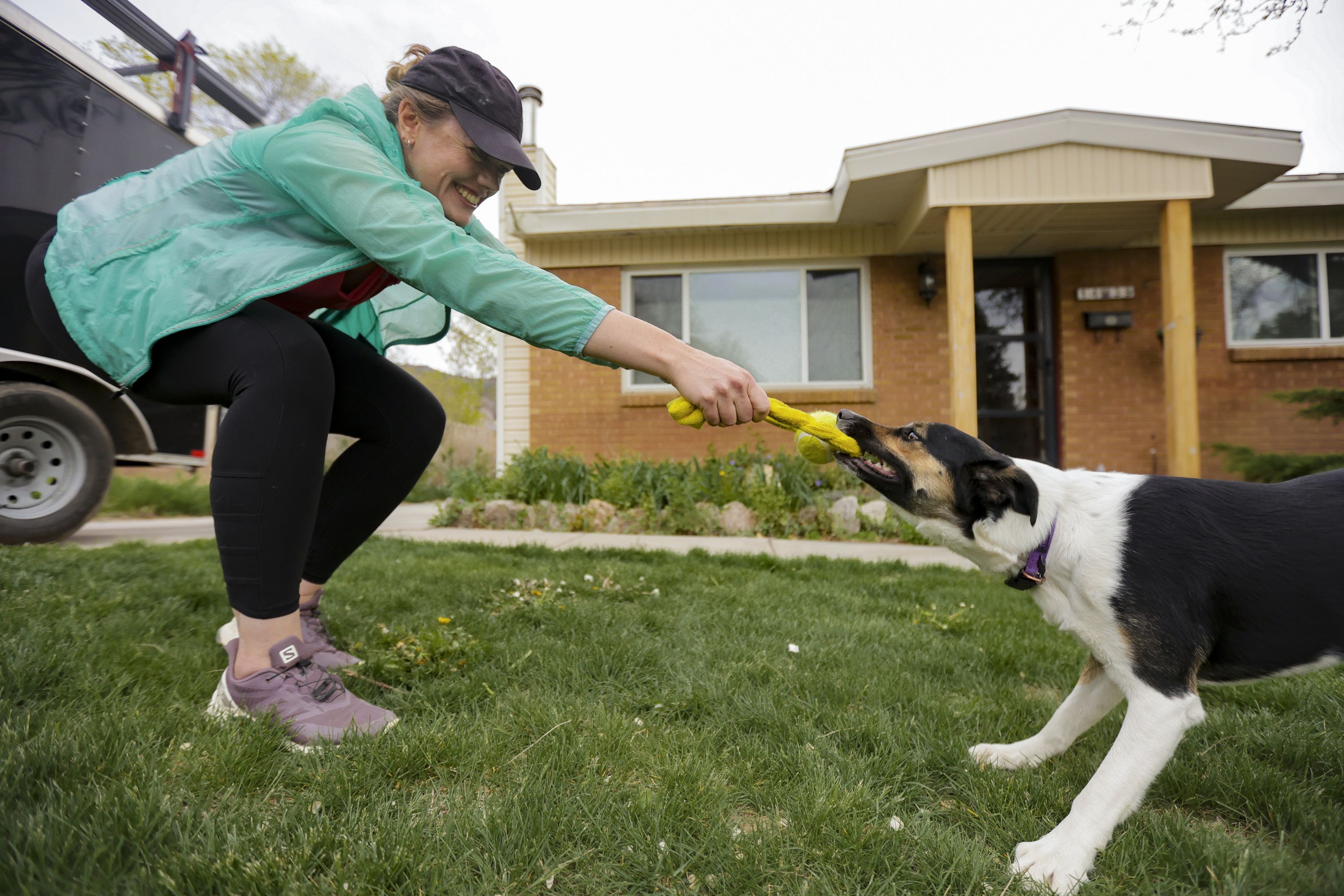 Lara Gale plays with her dog, Harvey, in front of her house in Ogden on May 12. As the price of housing shoots higher and higher into the clouds with no clear end in sight, millennials — and yes, Gen Z — are finding it nearly impossible to afford a home.