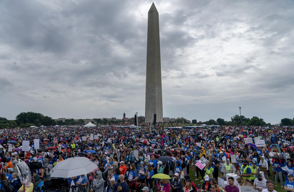 People participate in the second March for Our Lives rally in support of gun control in front of the Washington Monument, Saturday in Washington. The rally is a successor to the 2018 march organized by student protestors after the mass shooting at a high school in Parkland, Fla.
