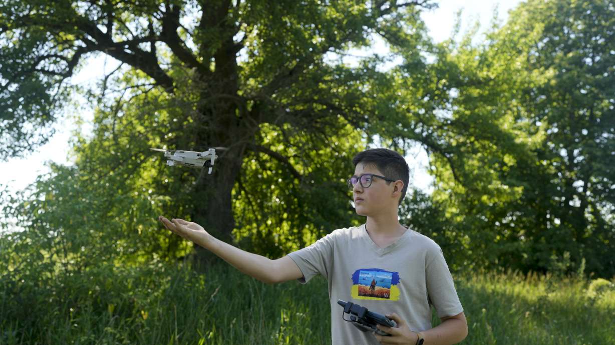 Andriy Pokrasa, 15, lands his drone on his hand during an interview with The Associated Press in Kyiv, Ukraine, Saturday. Andriy is being hailed in Ukraine for stealthy aerial reconnaissance work he has done with his dad in the ongoing war with Russia.