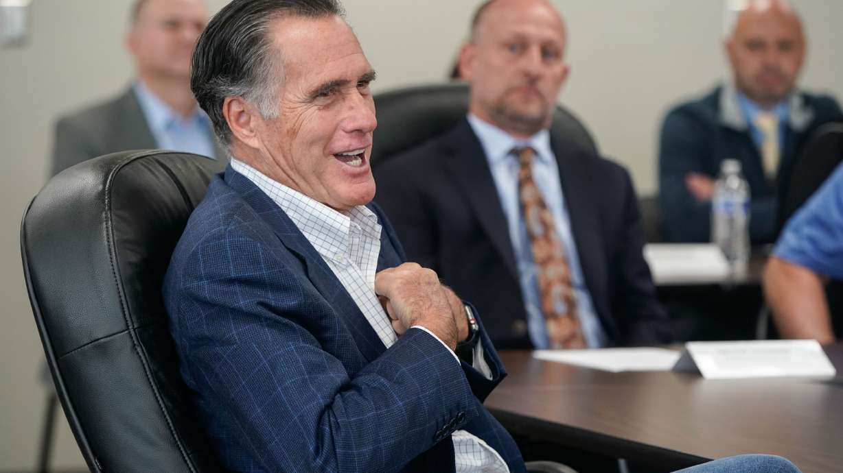 Sen. Mitt Romney, R-Utah, talks to Kenworth Sales employees before a tour of the company in West Valley City, Nov. 12, 2021. Romney is among a bipartisan group of senators who announced a framework Sunday for gun safety legislation.