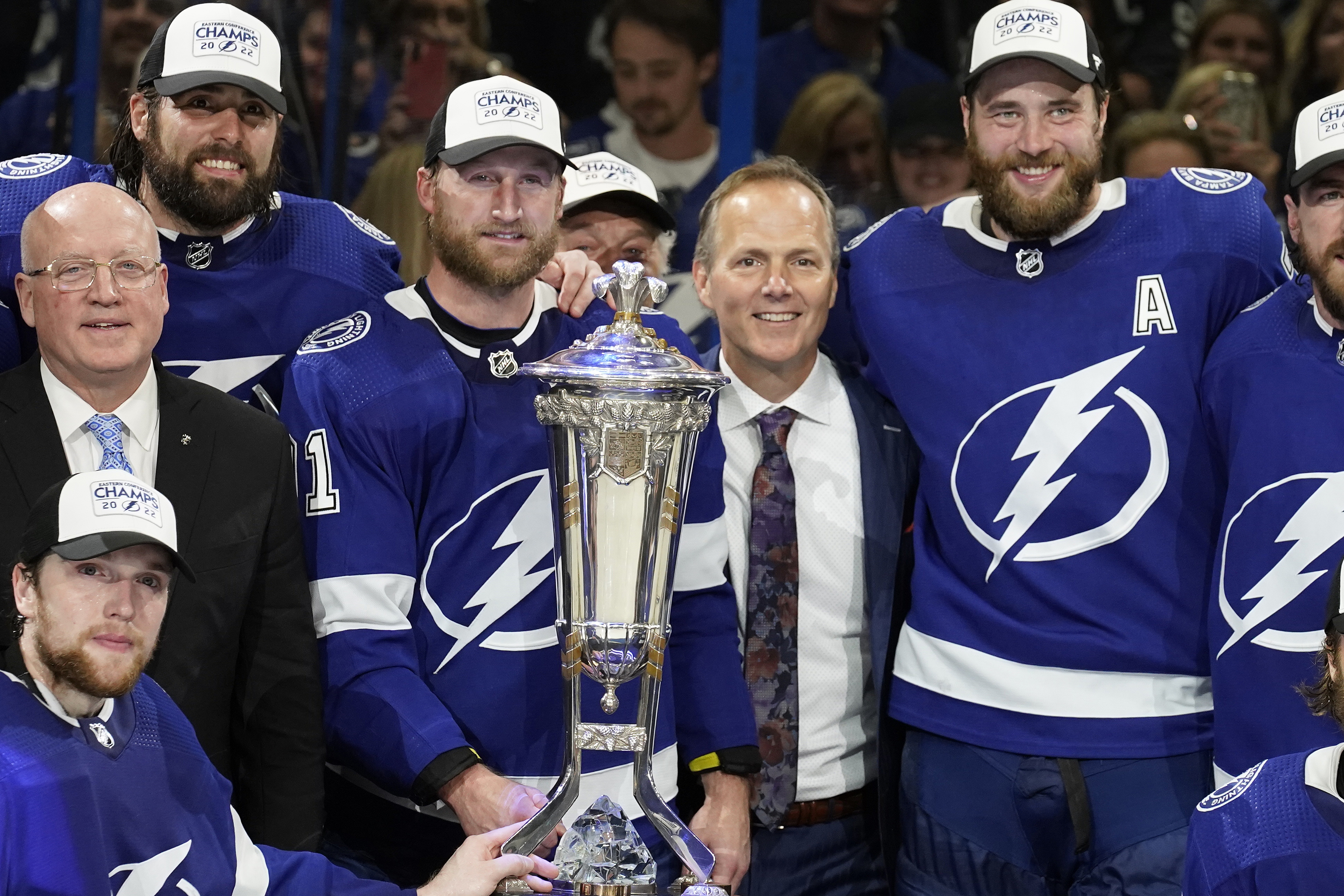 Tampa Bay Lightning center Steven Stamkos (91), head coach Jon Cooper, and defenseman Victor Hedman (77) pose with the Prince of Wales Trophy after the team defeated the New York Rangers during Game 6 of the NHL hockey Stanley Cup playoffs Eastern Conference finals Saturday, June 11, 2022, in Tampa, Fla. 