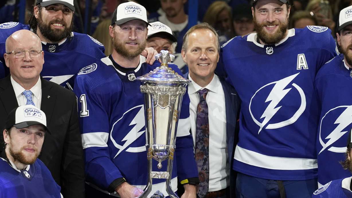 Tampa Bay Lightning center Steven Stamkos (91), head coach Jon Cooper, and defenseman Victor Hedman (77) pose with the Prince of Wales Trophy after the team defeated the New York Rangers during Game 6 of the NHL hockey Stanley Cup playoffs Eastern Conference finals Saturday, June 11, 2022, in Tampa, Fla.
