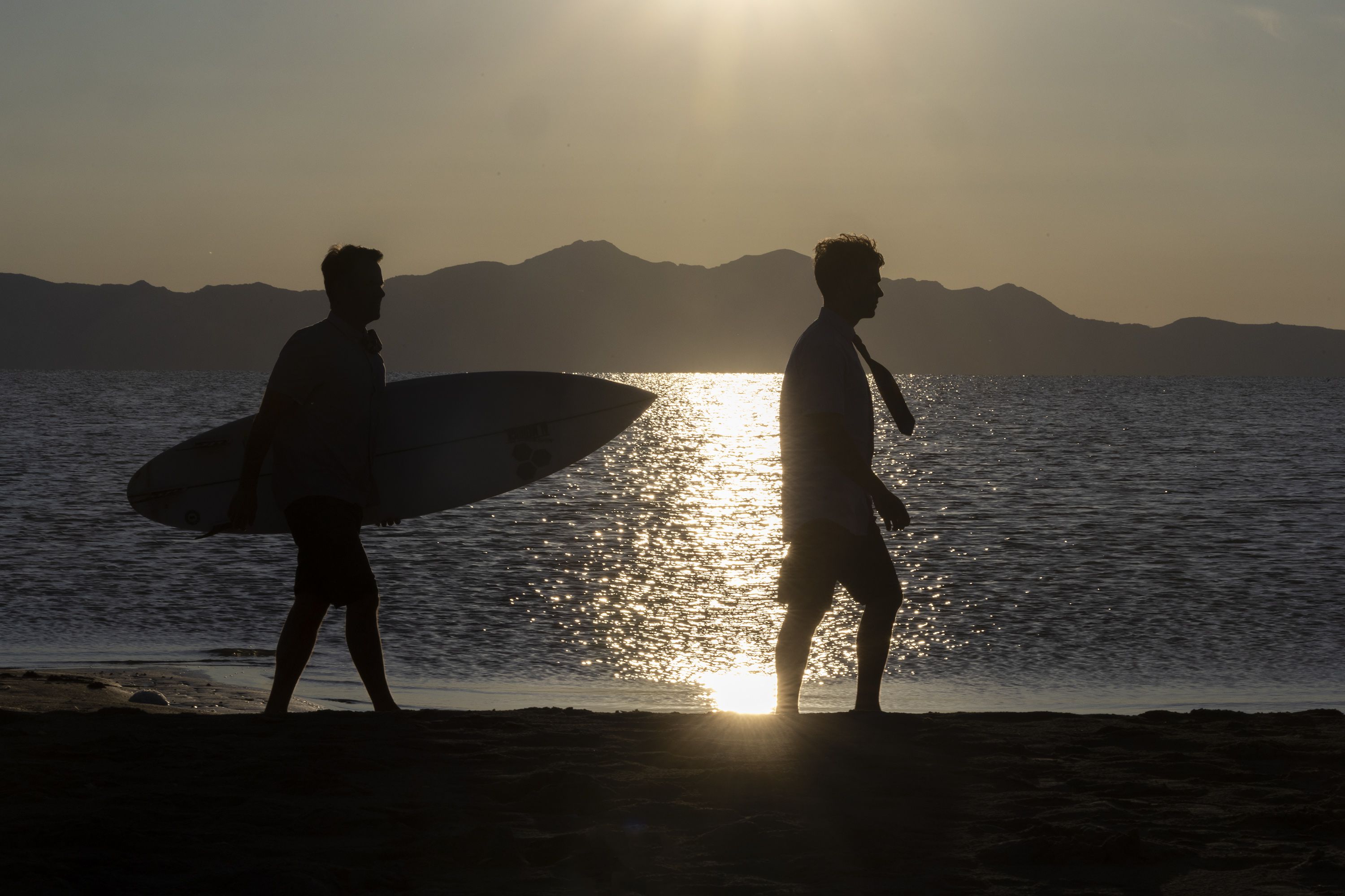 Gregg Greer and his son, Zeke walk on a beach at the Great Salt Lake near Salt Lake City on May 31. The pair’s ties are made of the quick-drying material used in surfer’s board shorts and are sold online, in surf shops and other retail outlets like Modern Missionary.
