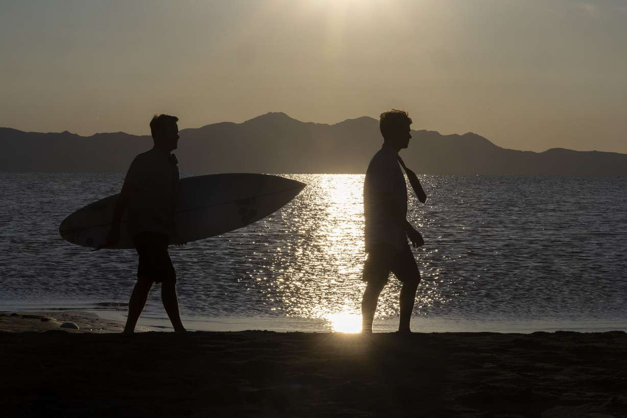 Gregg Greer and his son, Zeke walk on a beach at the Great Salt Lake near Salt Lake City on May 31. The pair’s ties are made of the quick-drying material used in surfer’s board shorts and are sold online, in surf shops and other retail outlets like Modern Missionary.