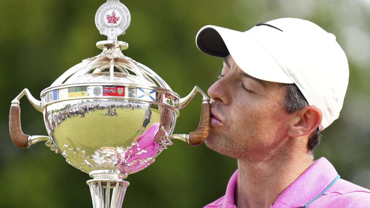 Rory McIlroy, of Northern Ireland, kisses the trophy after winning the final round of the Canadian Open golf tournament at St. George's Golf and Country Club in Toronto, Sunday, June 12, 2022.