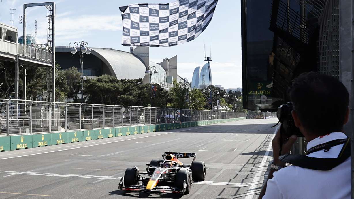 Red Bull driver Max Verstappen of the Netherlands crosses the finish line to win the Azerbaijan Formula One Grand Prix at the Baku circuit, in Baku, Azerbaijan, Sunday, June 12, 2022.