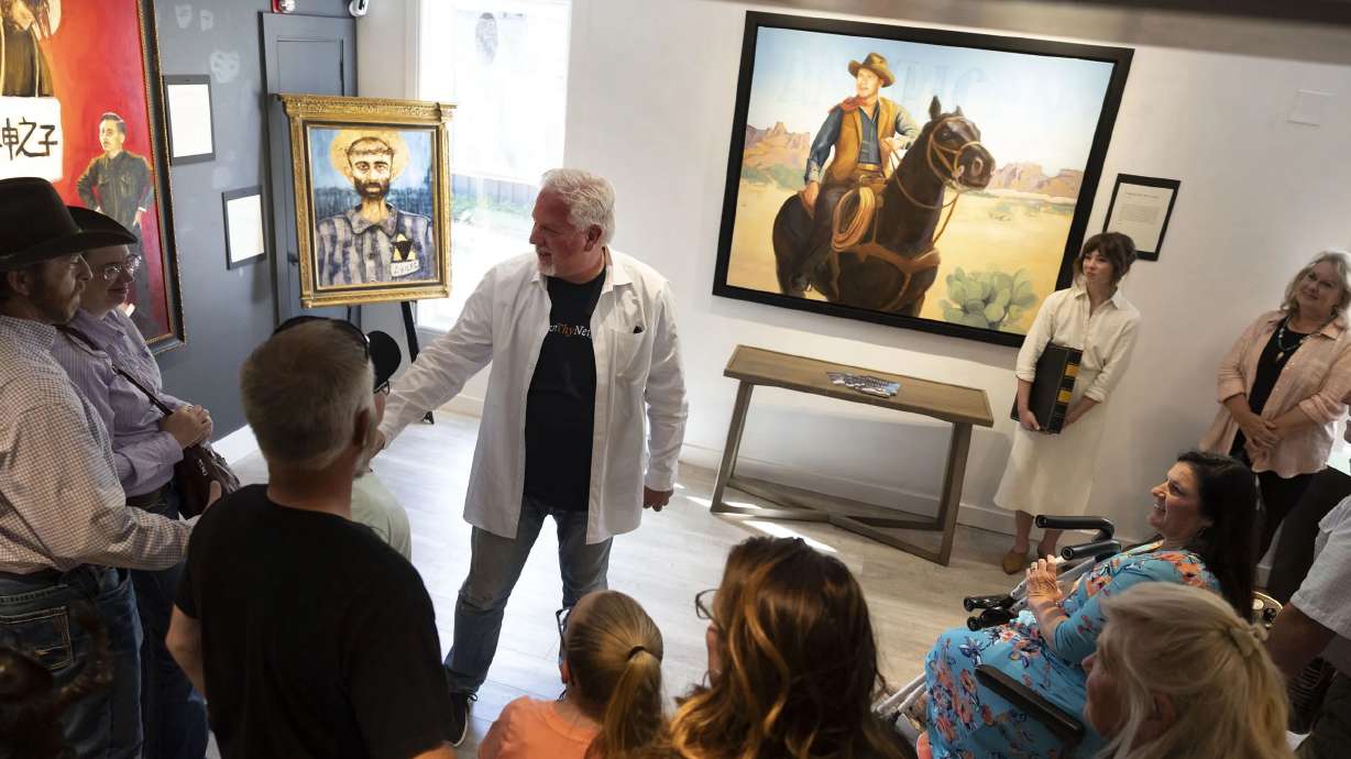 Gallery opening attendees listen to Glenn Beck talk about his work at Park City Fine Art on Friday, June 10, 2022.
