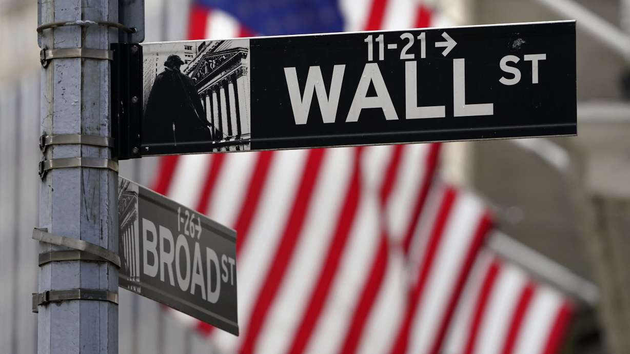 A Wall Street sign is displayed outside of the New York Stock Exchange in New York on Nov. 23, 2020. Following a worse-than-expected inflation report on Friday, U.S. stock indexes were down across the board on Monday.