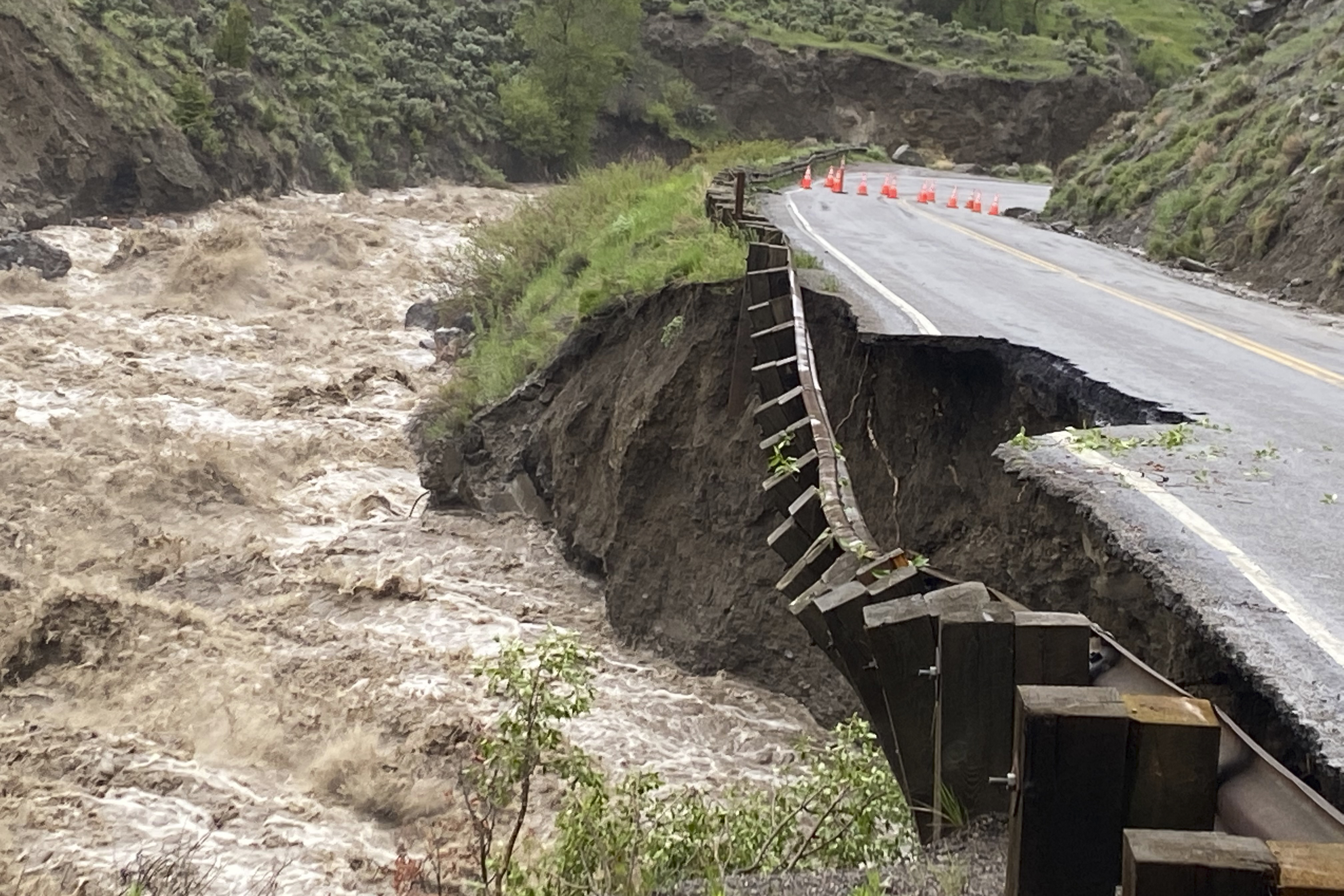 In this photo provided by the National Park Service, is high water in the Gardiner River along the North Entrance to Yellowstone National Park in Montana, that washed out part of a road on Monday.