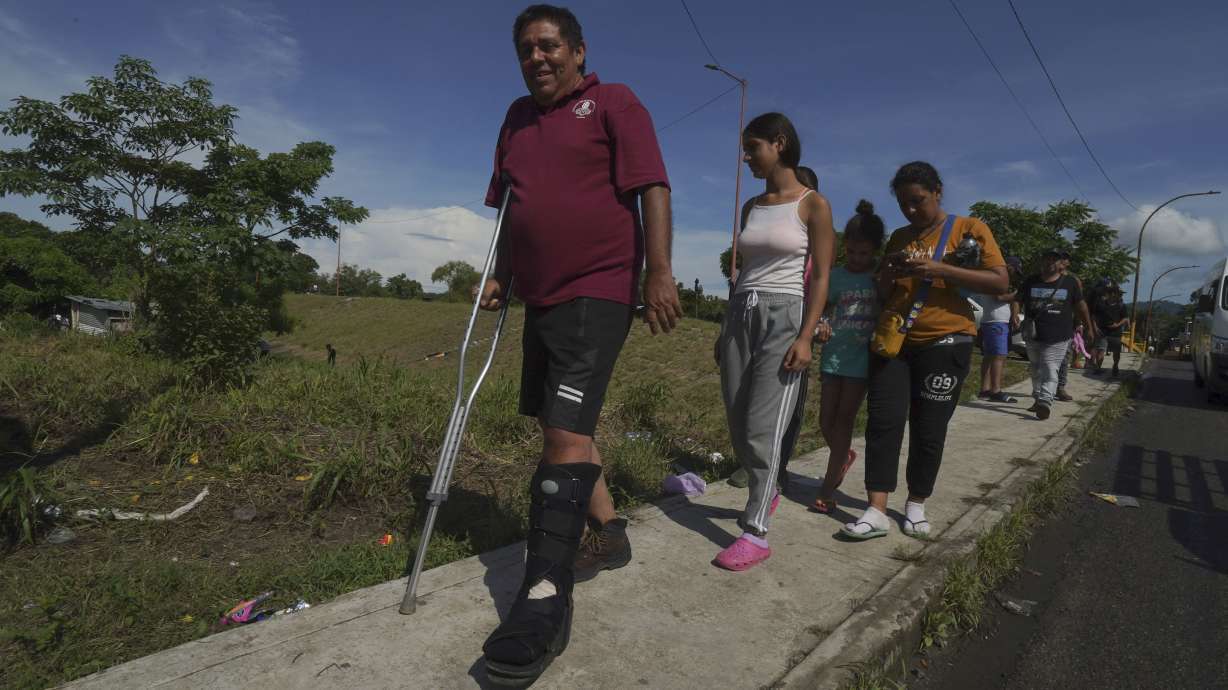 Venezuelan migrant Jesus Gonzalez, who broke his leg while crossing the Darien jungle, walks with his family who are part of a migrant caravan that has stopped to rest in Huixtla, Chiapas state, Mexico, on Wednesday. Venezuelans make up a large proportion of this caravan, the biggest of the year, in contrast to others in previous years.