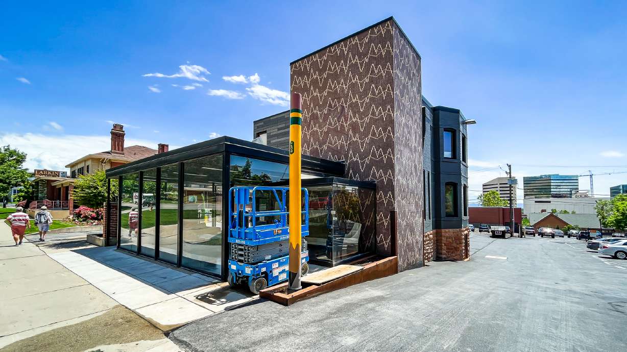 A large pencil public art sculpture outside of a business on South Temple in Salt Lake City Monday afternoon. Construction crews installed the art piece, made from a repurposed utility pole, earlier in the day.