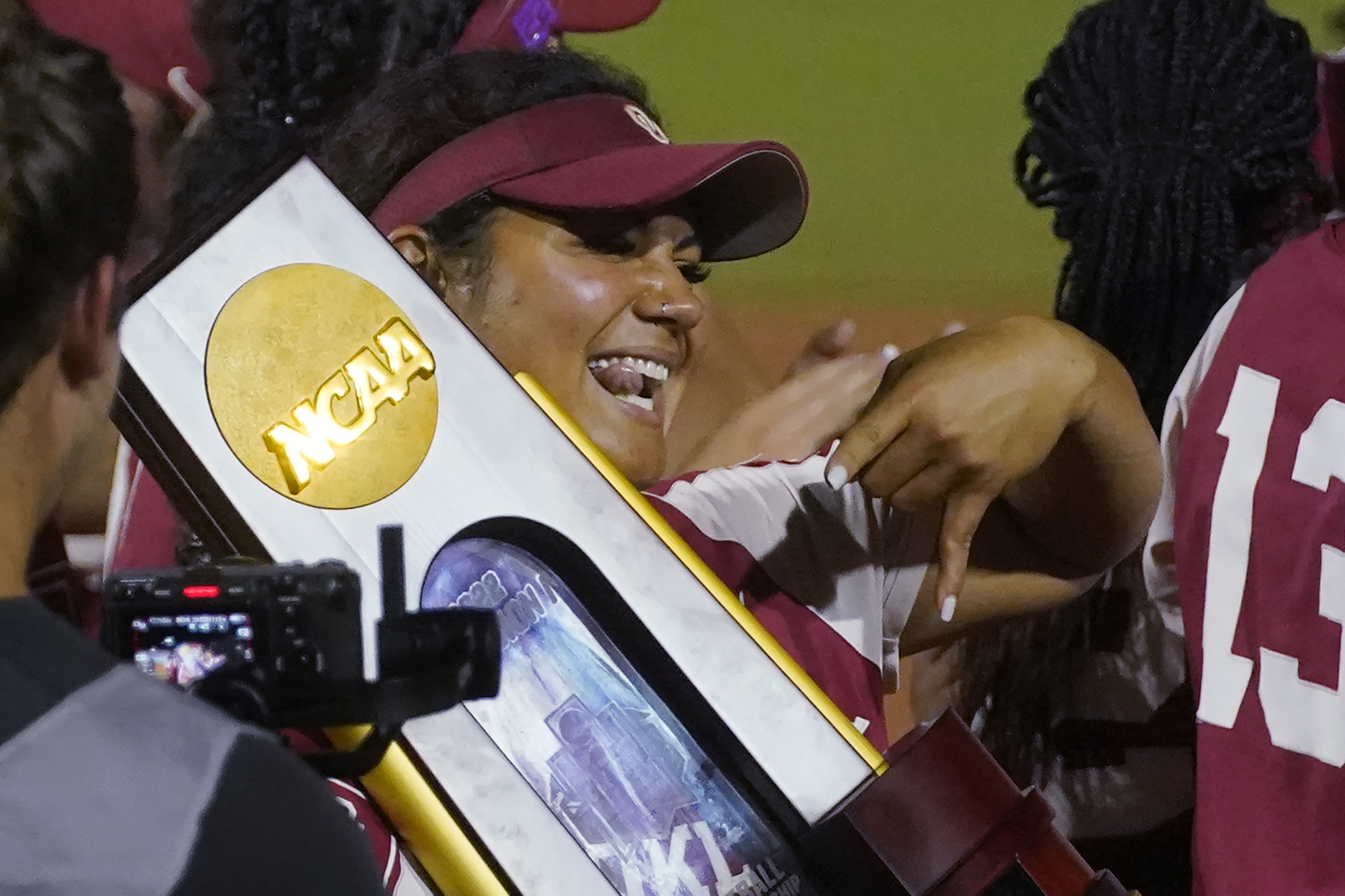 Oklahoma's Jocelyn Alo holds the trophy after Oklahoma defeated Texas in the NCAA softball Women's College World Series finals Thursday, June 9, 2022, in Oklahoma City. 