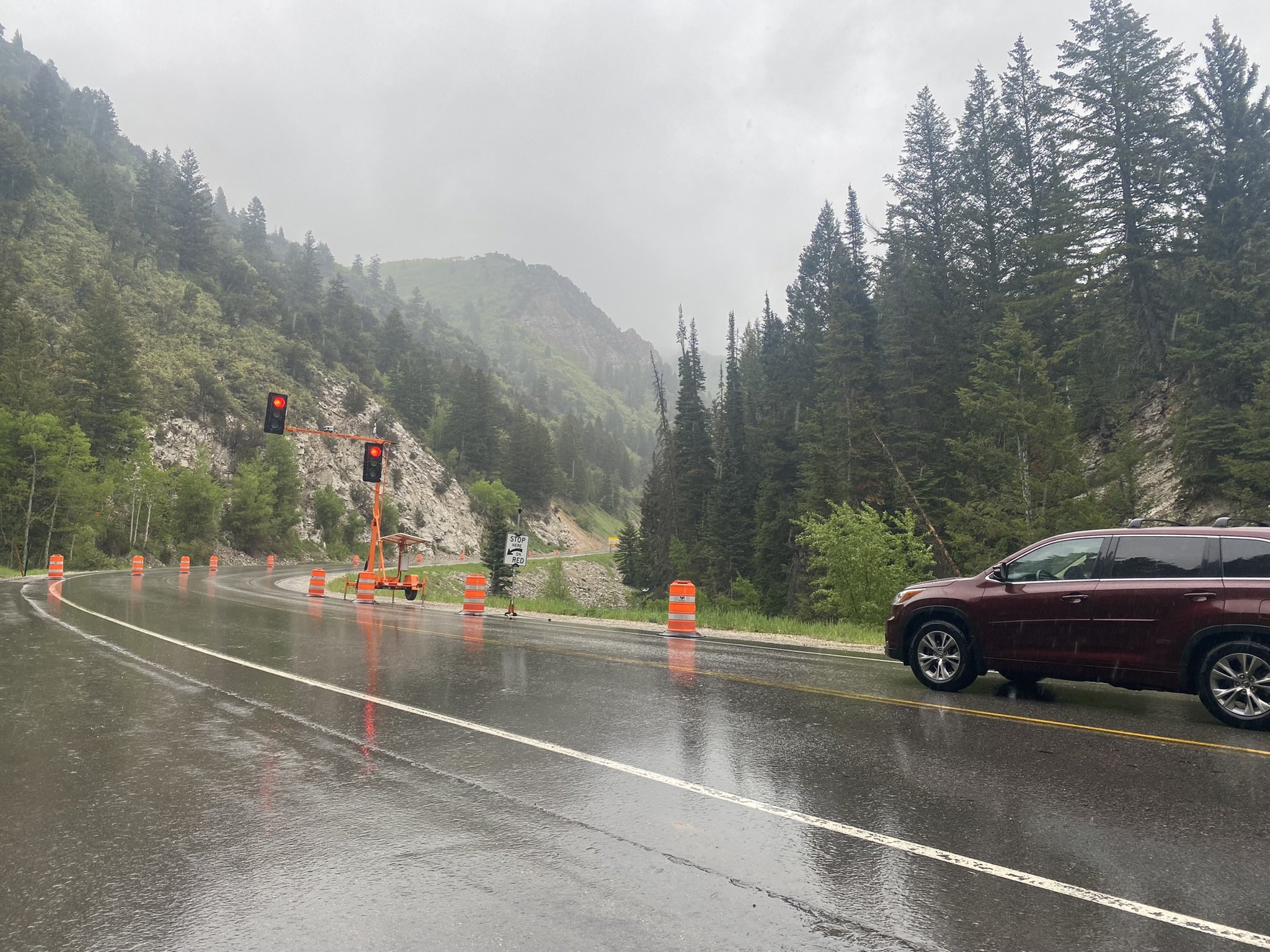 A vehicle stopped in the rain for a project in Big Cottonwood Canyon Monday. Parts of the Cottonwood Canyons received as much as a half-inch of rain during the day.