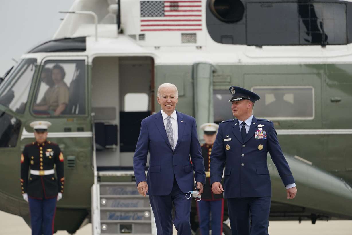 President Joe Biden walks toward Air Force One with Colonel Matthew Jones, Commander, 89th Airlift Wing, at Andrews Air Force Base, Md., Tuesday. Biden is traveling to Philadelphia to speak at the AFL-CIO convention on how he's trying to make the economy work for working-class Americans.