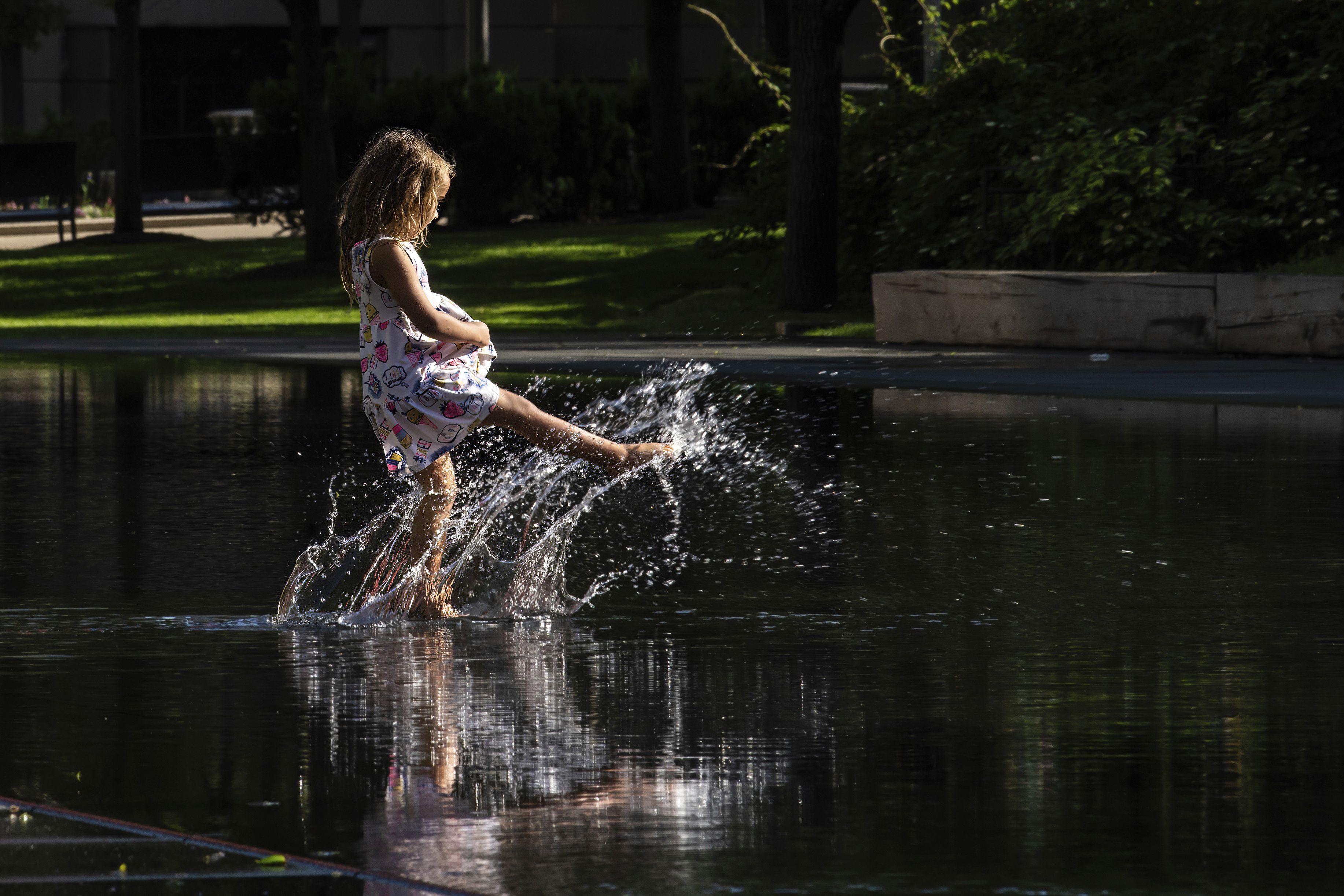 Aliz Kovacs Taylor, 5, plays with her mom in the Crown Fountain on Michigan Avenue, as temperatures spike in Chicago, Tuesday. A heat dome that settled over the western United States last week — leading to a record-breaking 102 degrees Sunday at the Salt Lake City International Airport — has spread to the East Coast.
