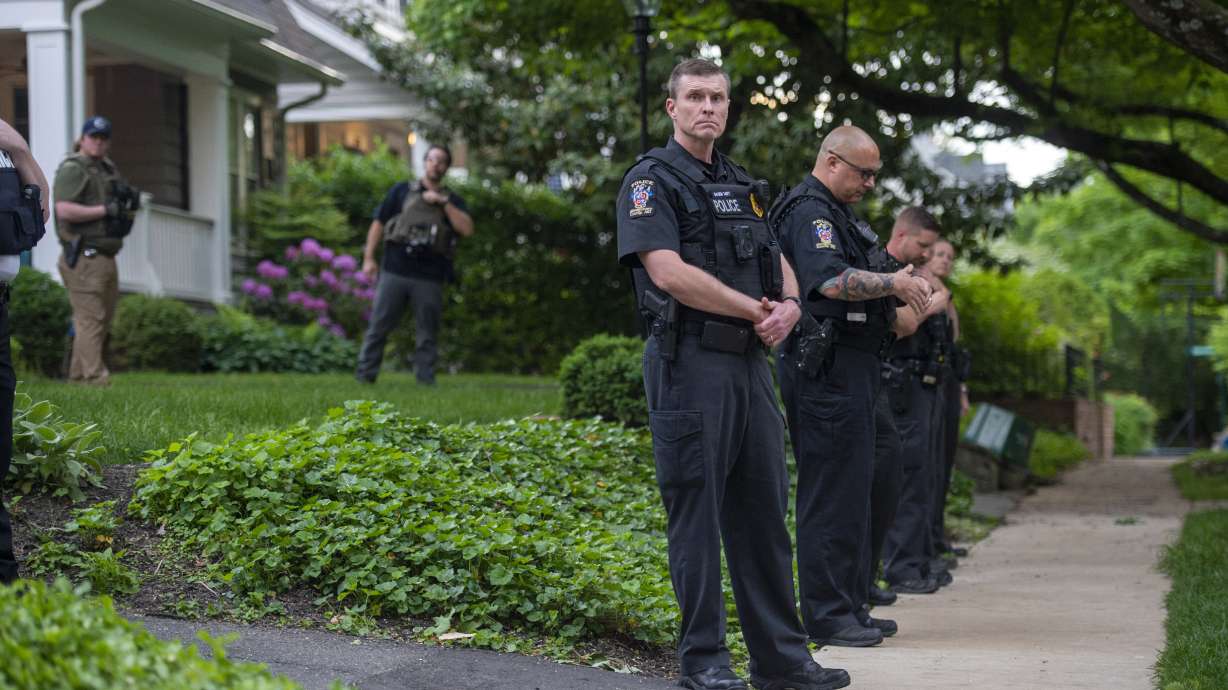 Police officers stand outside the home of U.S. Supreme Court Justice Brett Kavanaugh in anticipation of an abortion-rights demonstration on May 18 in Chevy Chase, Md. The man charged with the attempted murder of Justice Brett Kavanaugh was convinced to call 911 on himself by his sister as he stood nearby the judge's Maryland home, law enforcement said on June 14.