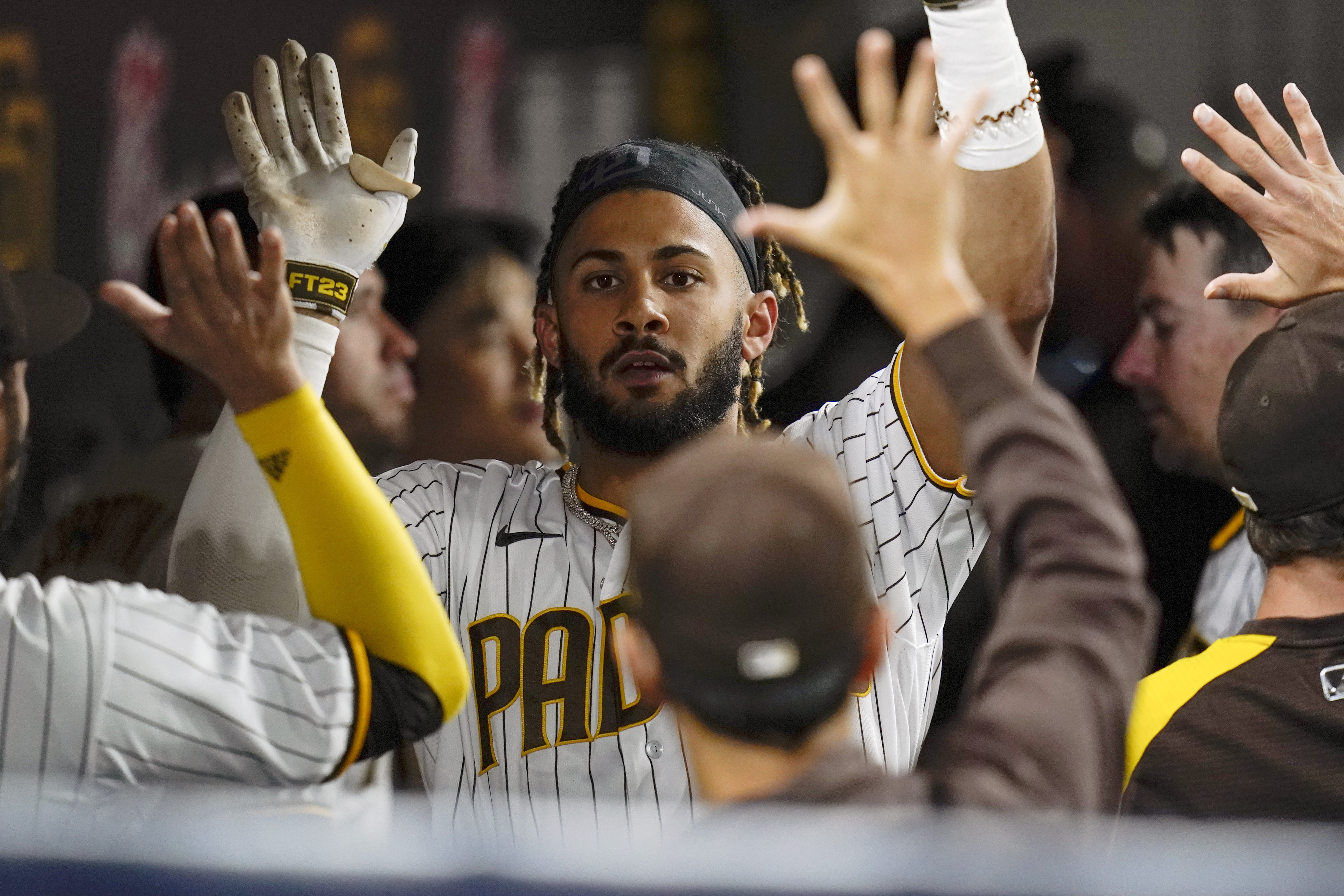 FILE - San Diego Padres' Fernando Tatis Jr. reacts with teammates after hitting a home run during the seventh inning of a baseball game against the Atlanta Braves, Sept. 24, 2021, in San Diego. Tatis Jr.'s surgically repaired left wrist hasn't progressed to the point where the electrifying All-Star shortstop can start swinging a bat, general manager A.J. Preller said Tuesday June 14, 2022. 