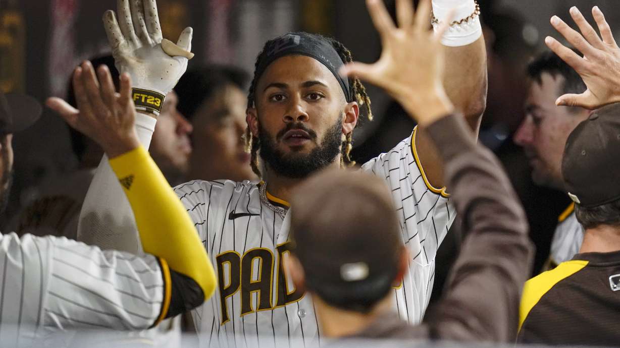 FILE - San Diego Padres' Fernando Tatis Jr. reacts with teammates after hitting a home run during the seventh inning of a baseball game against the Atlanta Braves, Sept. 24, 2021, in San Diego. Tatis Jr.'s surgically repaired left wrist hasn't progressed to the point where the electrifying All-Star shortstop can start swinging a bat, general manager A.J. Preller said Tuesday June 14, 2022.