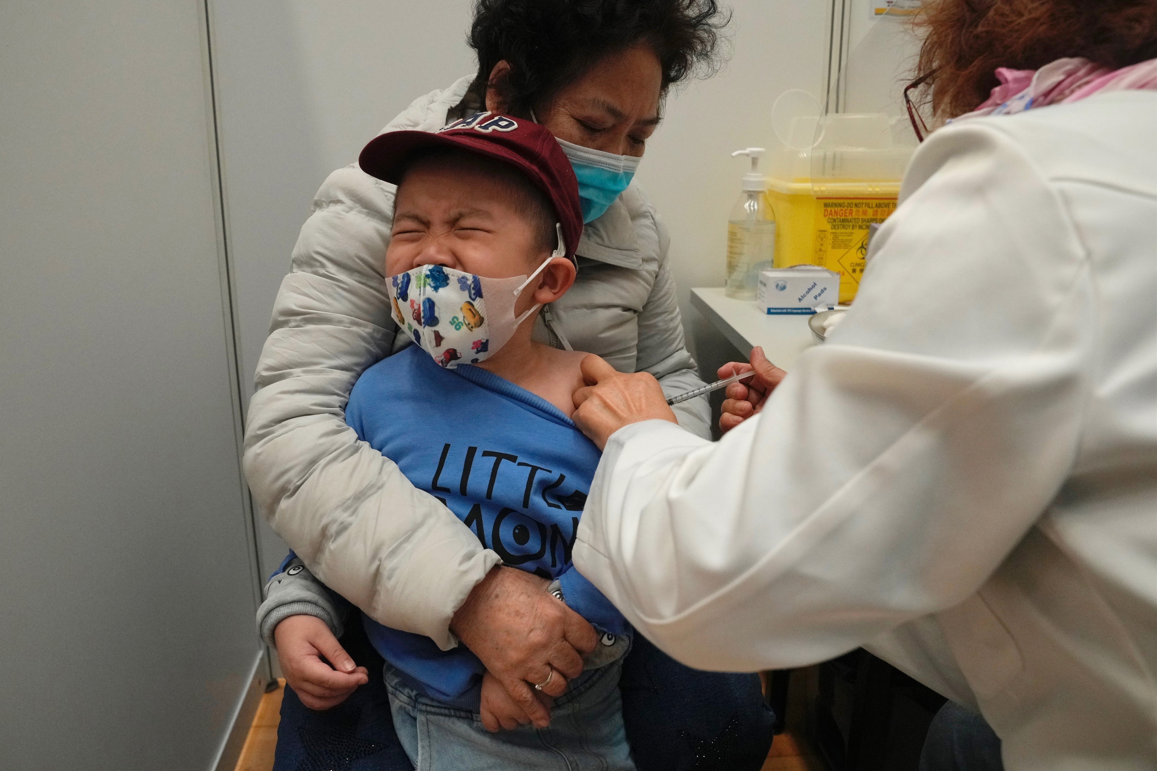 A boy receives a dose of China's Sinovac COVID-19 coronavirus vaccine at a community vaccination center in Hong Kong on Feb. 25. An advisory panel for the Food and Drug Administration gave a thumbs-up to Moderna's two shots for the littlest kids.