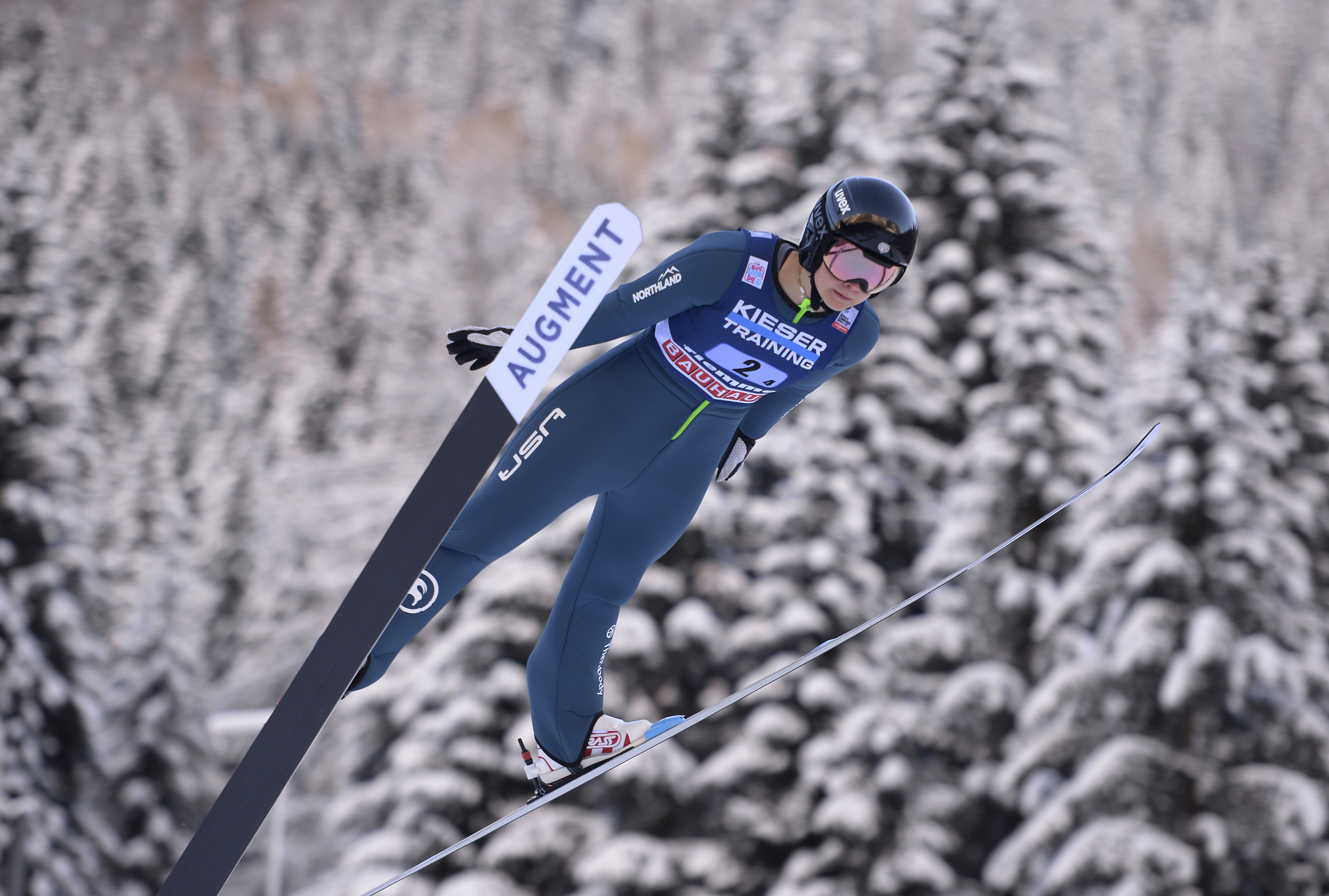 FILE - United States' Annika Malacinski competes during the Nordic combined World Cup mixed team normal hill HS 106, in Val di Fiemme, Italy, Jan. 7, 2022. Malacinski is one of dozens of women around the world who are in it for the glory, sacrificing a lot of time and money to go for Olympic gold. 