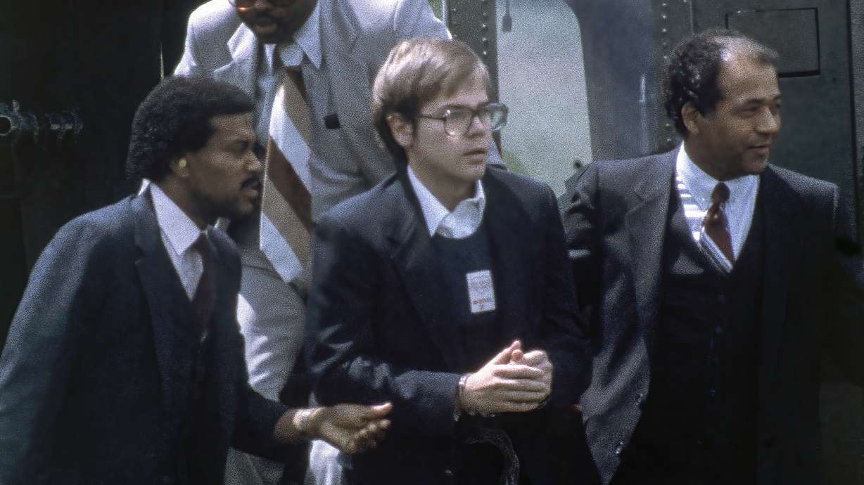 U.S. Marshalls escort John Hinckley Jr. as he returns to a marine base via helicopter in Quantico, Va. on Aug. 8, 1981. Hinckley, the man who shot President Ronald Reagan in 1981 is saying thank you to the people who helped him win freedom from court oversight.