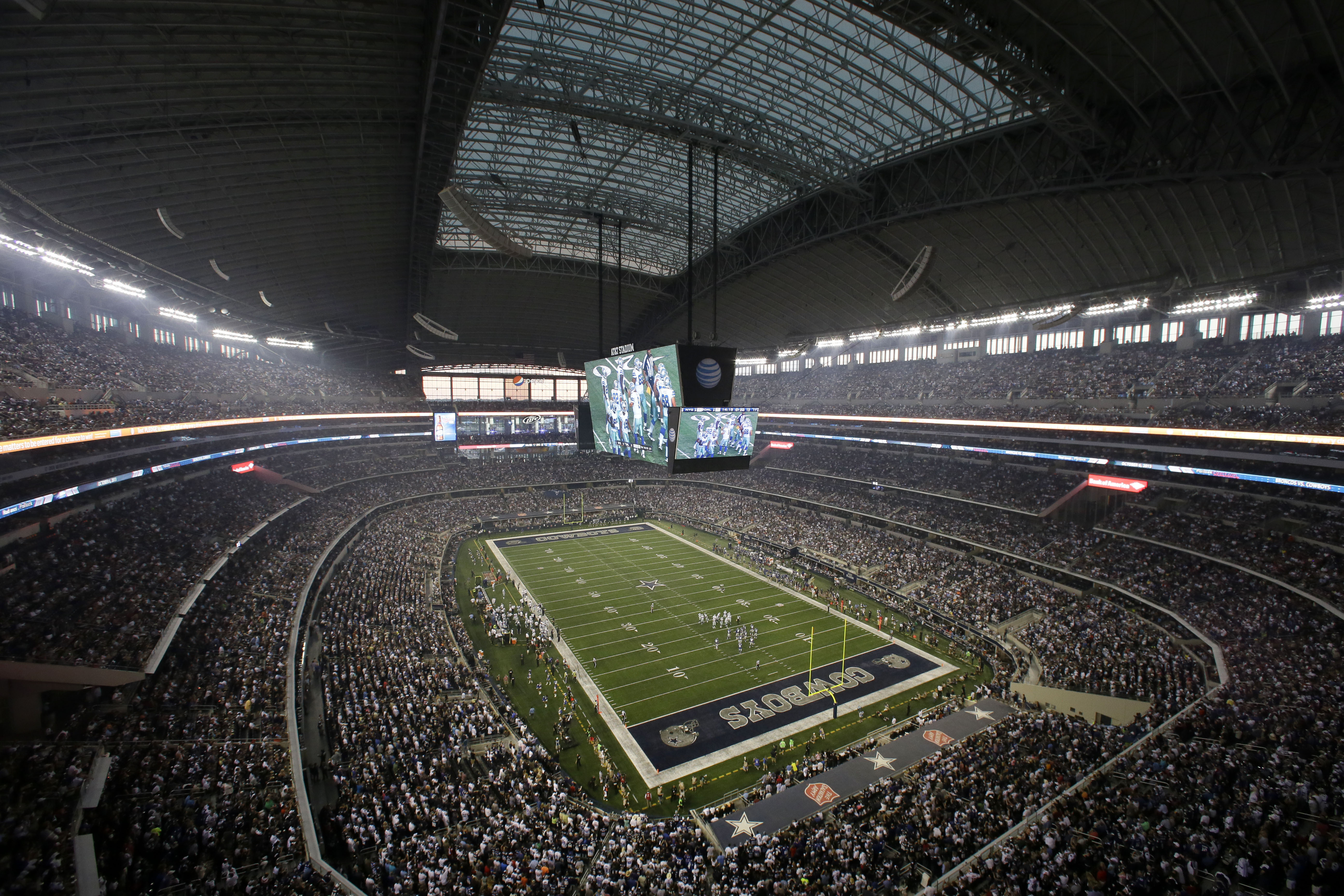 FILE - Fans watch at the start of an NFL football game inside AT&T Stadium between the New York Giants and Dallas Cowboys, Sunday, Sept. 8, 2013, in Arlington, Texas. There are 23 venues bidding to host soccer matches at the 2026 World Cup in the United States, Mexico and Canada. 