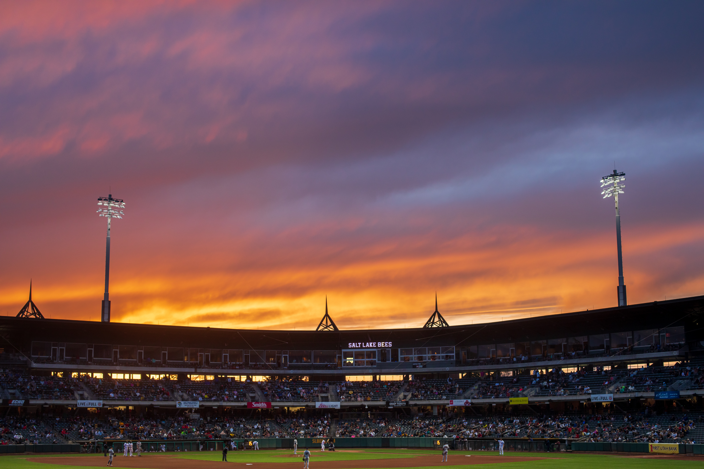 A sunset over Smith's Ballpark during a game on May 7. Salt Lake City, which owns the stadium, passed a resolution Tuesday that would keep the Salt Lake Bees at the stadium beyond 2024, which is when their current lease is set to expire. Future plans for the ballpark and surrounding neighborhood are also emerging.