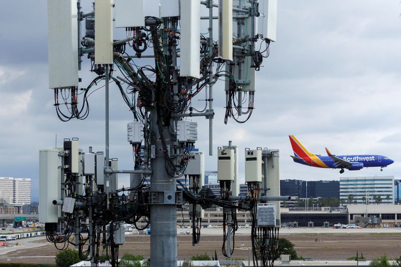 A Southwest commercial aircraft flies past a cell phone tower as it approaches to land at John Wayne Airport in Santa Ana, California, on Jan. 18. The acting head of the Federal Aviation Administration on Wednesday urged the chief executives of major U.S. airlines to move quickly to address risks of C-Band 5G interference with sensitive airplane electronics.