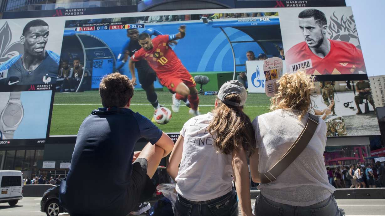 FILE - French soccer fans watch France play Belgium in a World Cup semifinal soccer game on a gigantic screen in New York's Times Square, on July 10, 2018, in New York. U.S. cities and states have lined up with tax breaks and millions of dollars in both public and private investments for a chance at hosting 2026 FIFA World Cup games, set to be announced Thursday, June 16, 2022.