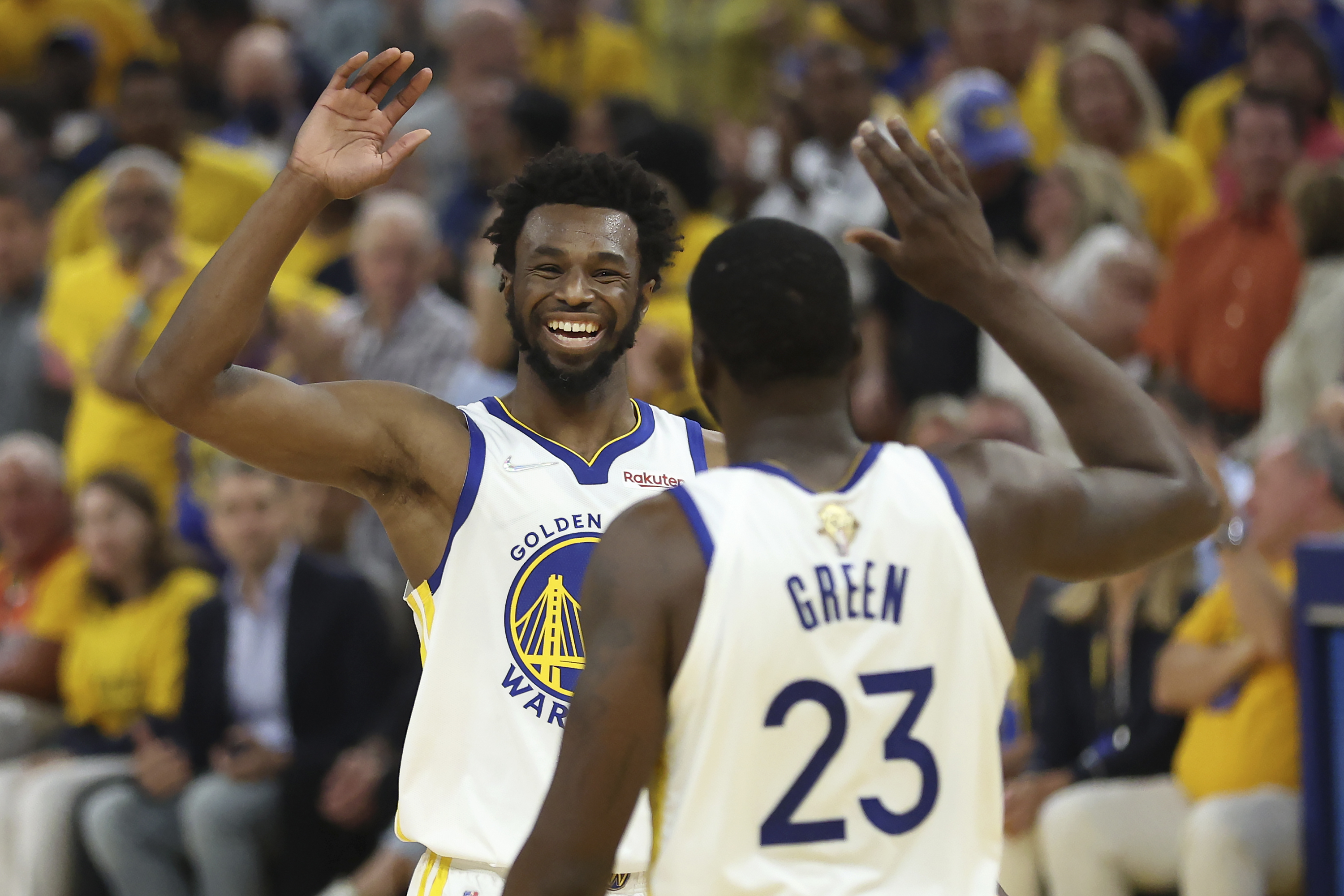 Golden State Warriors forward Andrew Wiggins, left, celebrates with forward Draymond Green (23) during the first half of Game 5 of basketball's NBA Finals against the Boston Celtics in San Francisco, Monday, June 13, 2022. 