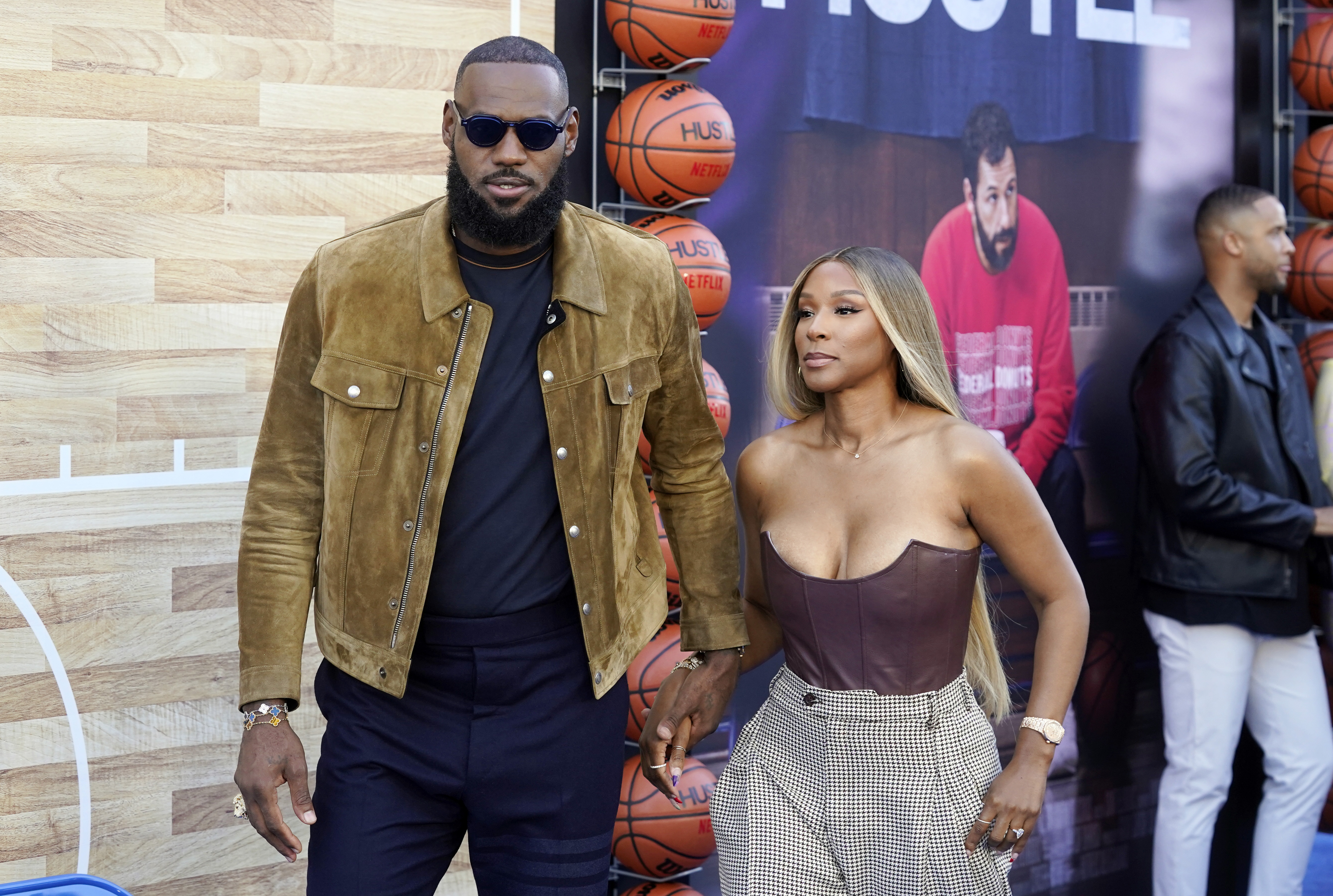 NBA basketball player LeBron James, a producer of the Netflix film "Hustle," and his wife Savannah arrive at the premiere of the film, Wednesday, June 1, 2022, at the Regency Village Theatre in Los Angeles. 
