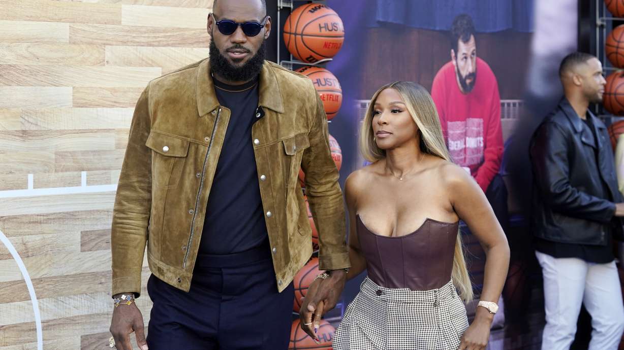 NBA basketball player LeBron James, a producer of the Netflix film "Hustle," and his wife Savannah arrive at the premiere of the film, Wednesday, June 1, 2022, at the Regency Village Theatre in Los Angeles.