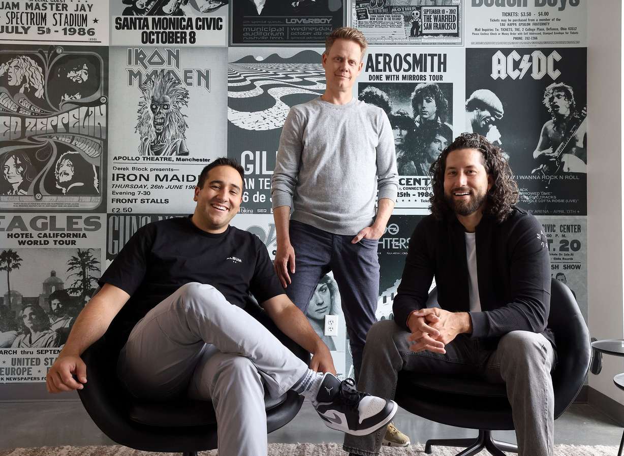 Album partners Diogo Myrrha, left, John Mayfield and Sid Krommenhoek pose for a portrait at the Album office in Lehi on May 9. They covered the walls with some of their favorite album covers, in reference to the name of their company.