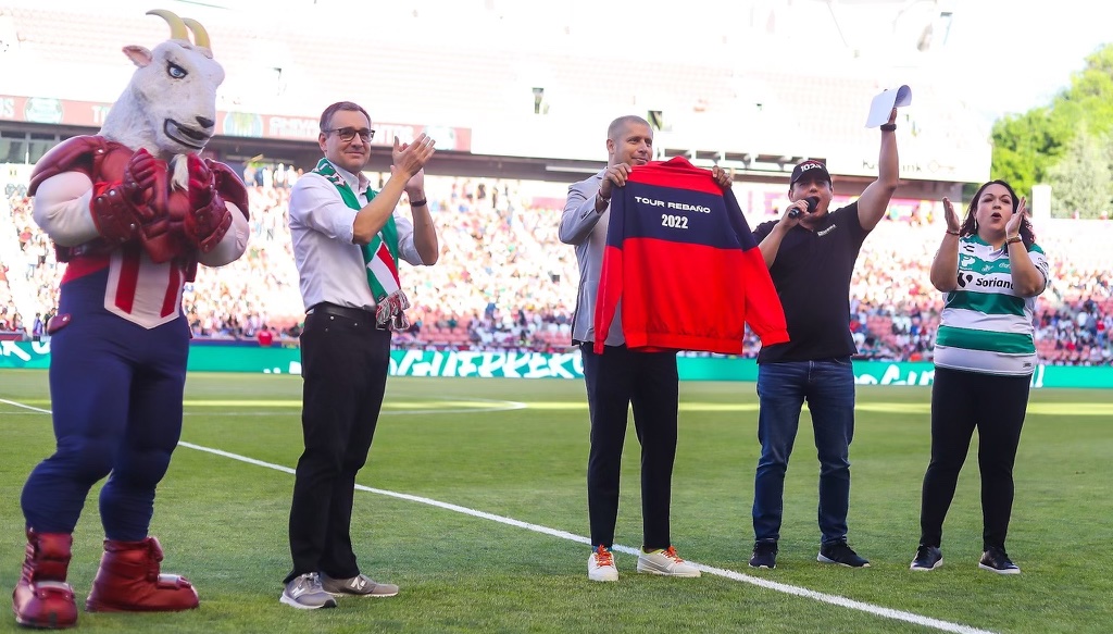Chivas club legend Adolfo "Bofo" Bautista, middle, accepts a jacket from Utah State Senator Luz Escamilla, far right.