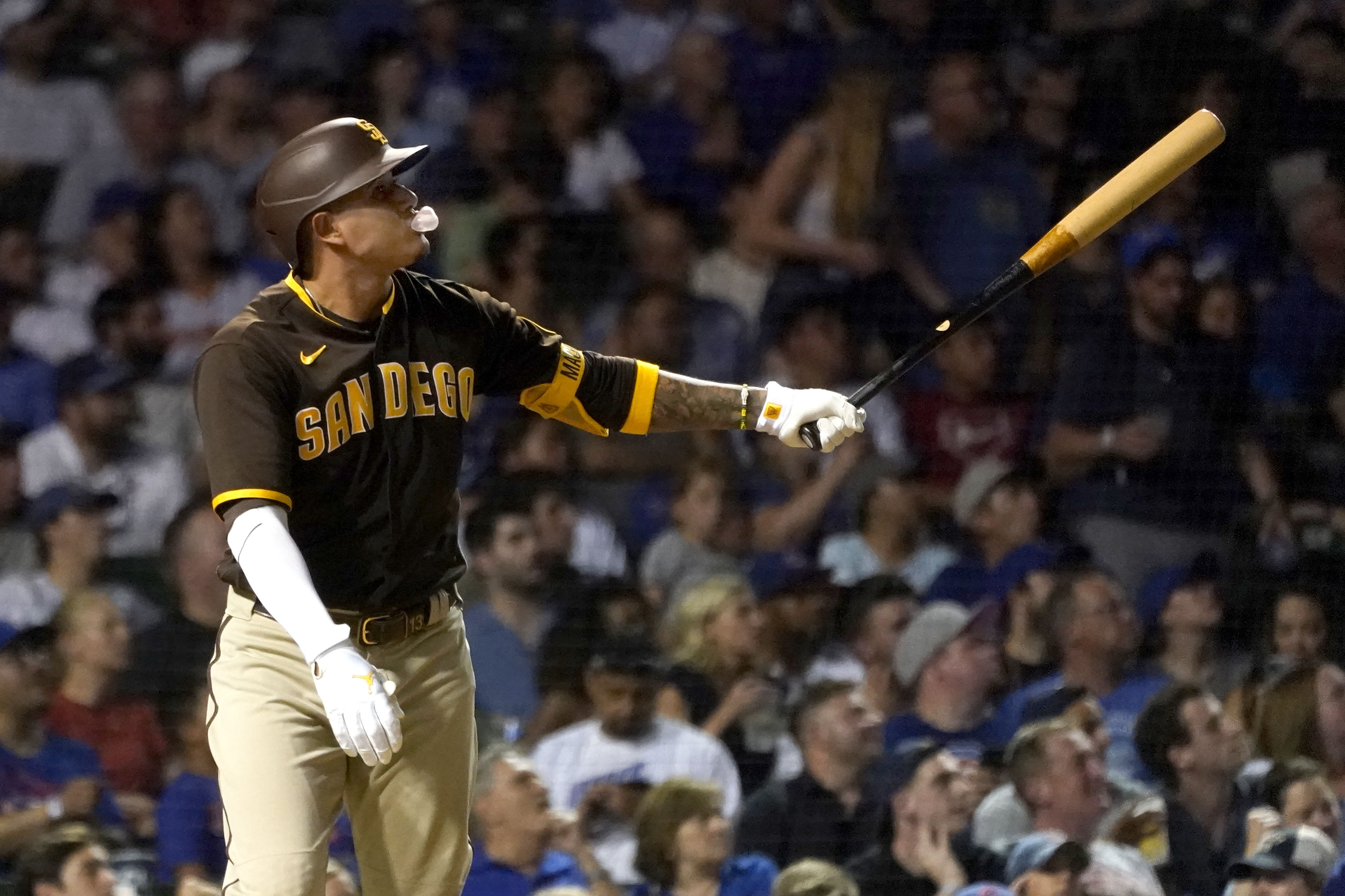San Diego Padres' Manny Machado blows a bubble as he watches his two-run home run off Chicago Cubs relief pitcher Rowan Wick during the fifth inning of a baseball game Wednesday, June 15, 2022, in Chicago. 