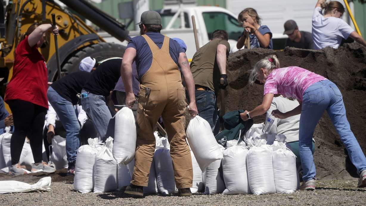 Volunteers fill sand bags Wednesday in Livingston, Mt.